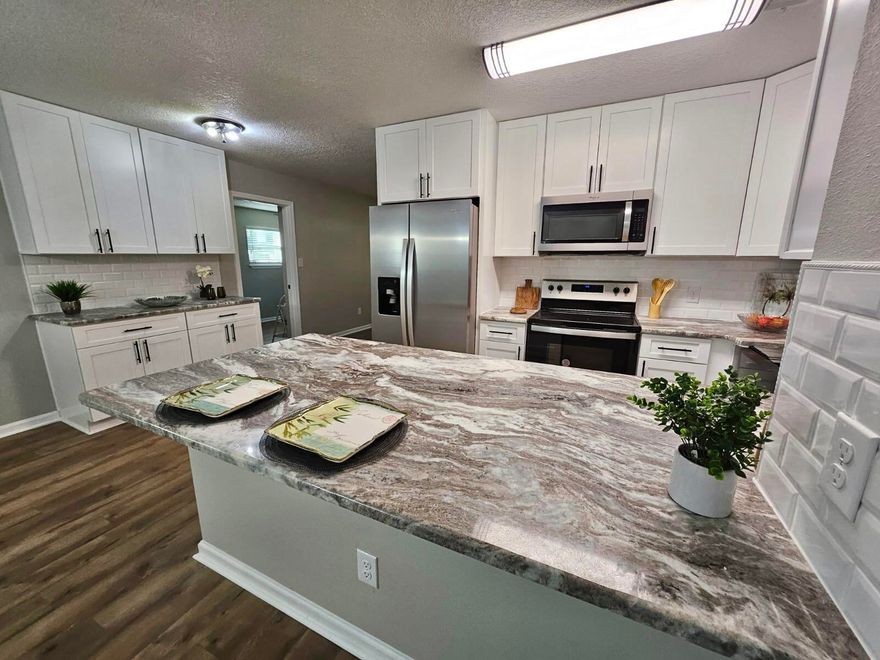 Va,Fha qualified!! $10K Seller Closing Costs assistance. Brick 100%- Everything Updated pn this 3/1.5 with 1458 Feet! Completely remodeled home - ready for you now! 100% Updated New Roof, New AC and duct work and Hot Water Heater, NEW WINDOWS, and NEW FENCE. New plumbing & Wiring. New kitchen with Granite counter-tops, backsplash and stainless steel appliance package. New baths with new vanity, lights, mirror and tile around tub and luxury vinyl flooring New paint inside & out, New laminate flooring in entire home except baths. New fans and lights, door knobs and hinges including interior doors.