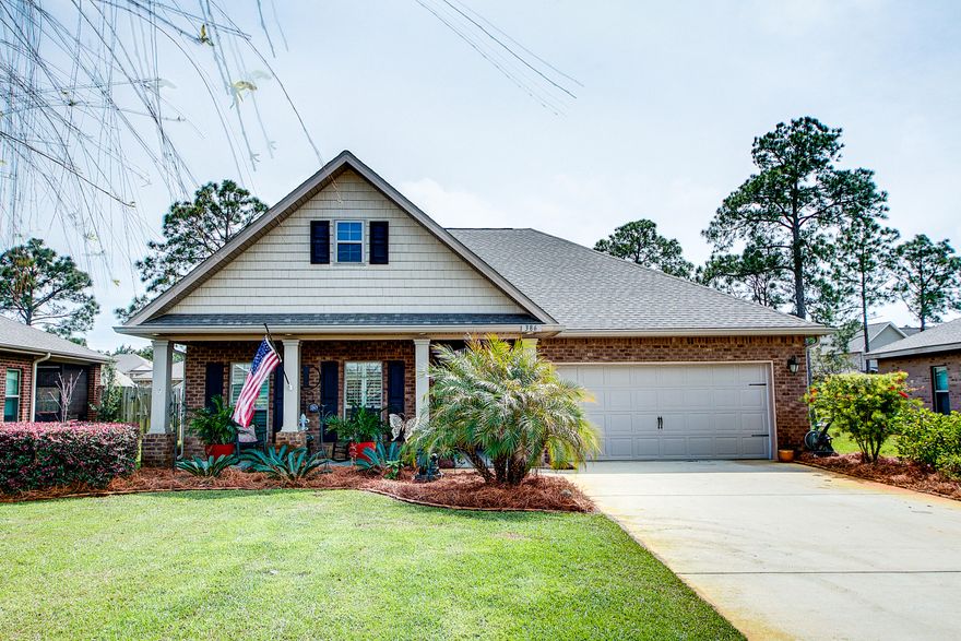 Charming 3-bedroom, 2-bath home with great curb appeal and beautiful landscaping. This home is ideally one level with 4-sided brick and hardboard exterior with a 2-car garage. The cozy front porch gives such a warm welcome with plenty of seating and gathering space. The beautiful front door leads to a spacious open floor plan featuring vaulted ceilings, hardwood floors and separate dining area just off the kitchen. The kitchen feels warm and rich with gorgeous granite countertops and deep wood cabinetry. Just beyond the living & dining area is a large back patio. This diverse outdoor space is great for entertaining with covered & uncovered options. The covered seating area features a ceiling fan beneficial for summer months in Florida. The backyard is fully fenced & provides great privacy.