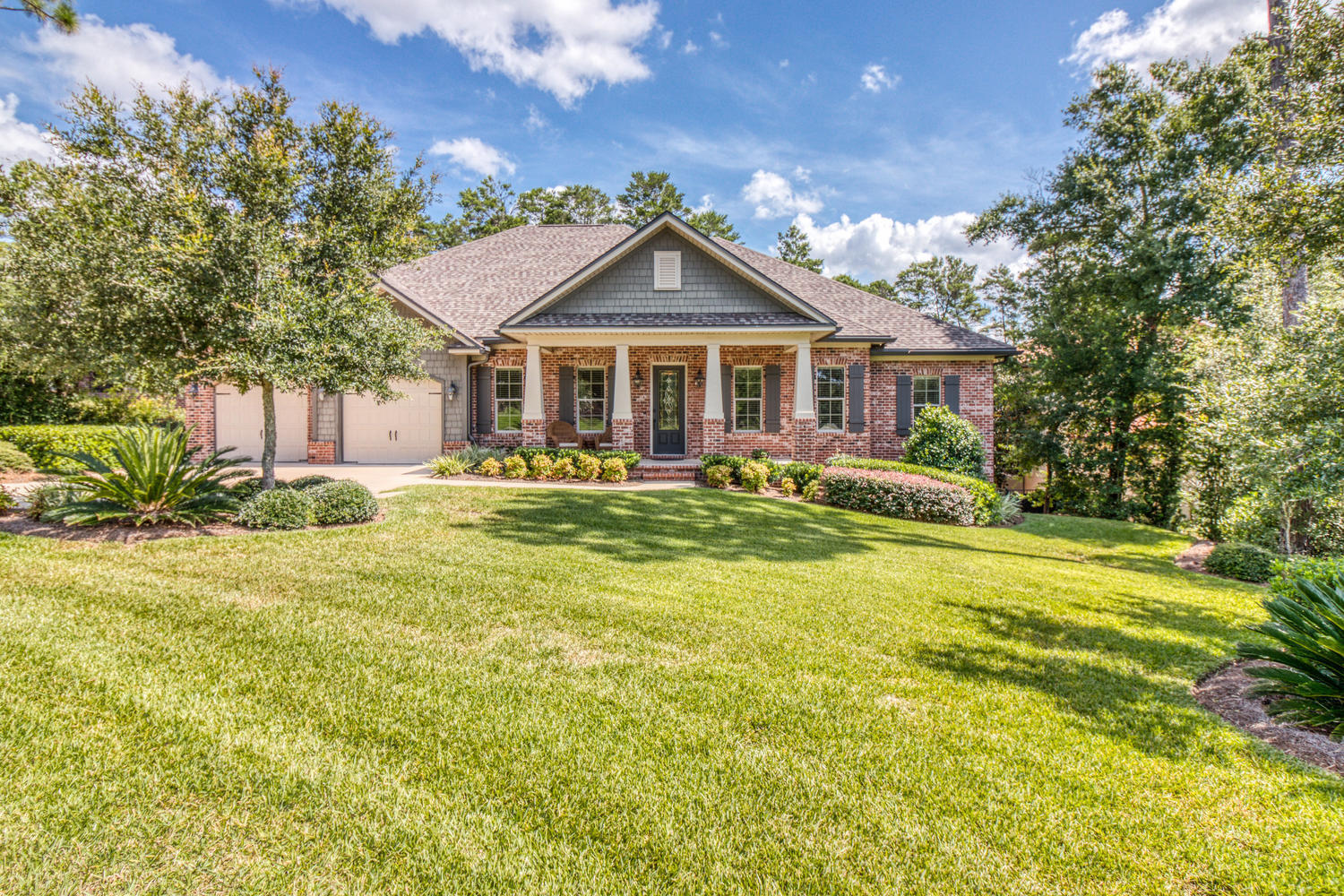 Enjoy the beautiful Randy Wise home with many custom details and privacy located within a short walk to Swift Creek 's pool and tennis & basketball courts. Two covered porches provide views of a professionally landscaped front yard and the deep private naturally wooded back yard. The interior features include beautiful custom crafted cherry stained walnut cabinetry throughout the kitchen, around the living room's stacked stone gas fireplace, and in all three baths with granite countertops. The kitchen appliances include upgraded stainless steel gas double ovens and cooktop plus a large refrigerator/freezer. Hand scraped engineered wood floors are throughout the main living living ares, dining room, den, and hallways.