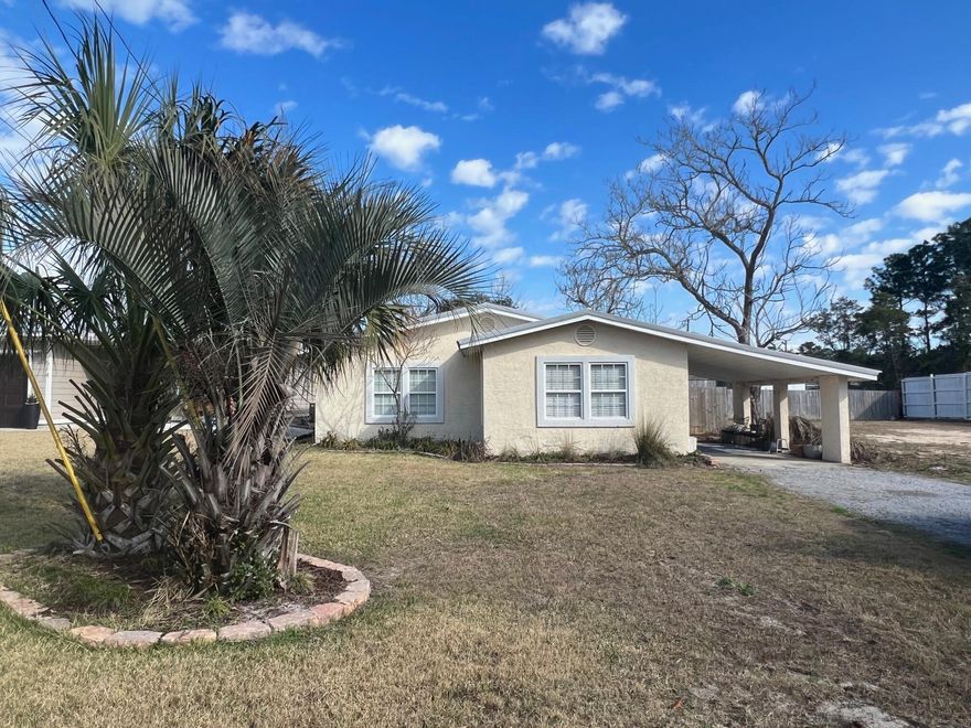 This adorable, cozy beach cottage, located in the coveted west end of Panama City Beach, would make a fantastic first home for a first time home buyer, a vacation rental or a great building lot! Once entering the home, there is an open living, dining and kitchen area that is inviting and spacious. Great for entertaining! The kitchen boasts newer appliances, the interior has been freshly painted, there is tile flooring throughout and the two nice sized bedrooms are carpeted. This house has a carport, which can also be used as a seating area for entertaining, the driveway is large enough for four vehicles and all of this is situated on a sizeable lot that is only a few minutes away from the gorgeous beaches and Lake Powell! It's also within a short distance to all conveniences.