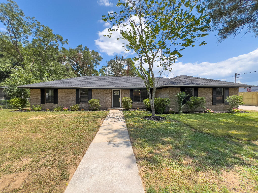 Welcome to this stunning all brick home that features 3 bedrooms and 2 bathrooms, complete with designer finishes on a spacious .35-acre lot. The open-concept floor plan effortlessly blends the living, dining, and kitchen areas. The kitchen boasts plenty of cabinetry, brand new stainless steel appliances, a large island with quartz countertops, and a stylish tile backsplash with gold accents. The primary bedroom includes an en-suite bathroom with a chic designer touch. Two additional bedrooms and a full bathroom provide plenty of space for family, guests, or a home office. New Roof, New HVAC system, New Water Heater, New Hardware, freshly painted, and New LVP flooring throughout, this home is brimming with upgrades!