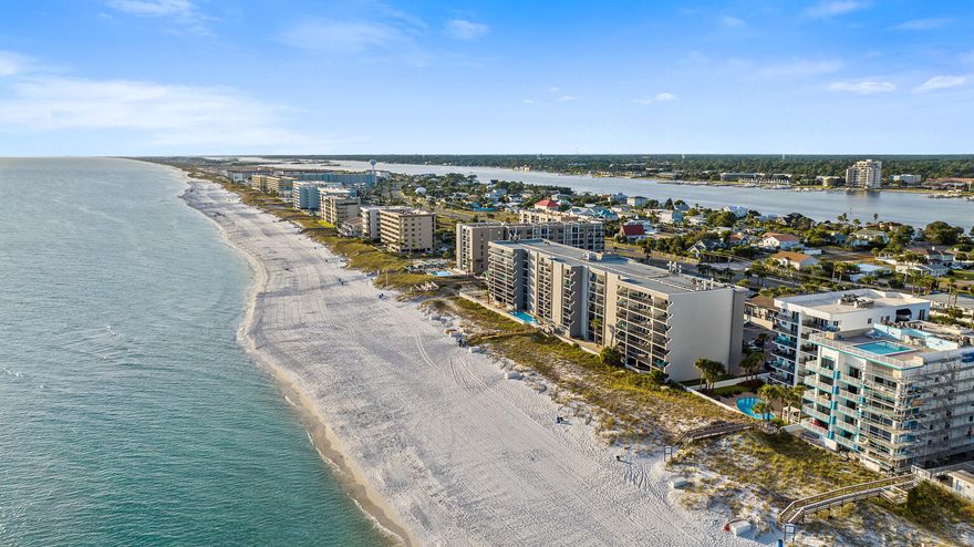 Experience Gulf-front living in this beautifully updated 2-bedroom, 2-bath condominium located in a gated building with only 20 units and a recently completed exterior renovation. The spacious, open-concept living area is filled with natural light and opens to a private balcony. Luxury vinyl plank flooring extends throughout the living areas and bedrooms, adding to the coastal appeal. The well-appointed kitchen features updated stainless steel appliances and ample counter space for cooking and entertaining. A split-bedroom layout provides privacy, with each bedroom offering its own en-suite bath. Additional conveniences include a full-size washer and dryer, walk-in closet, and two owner's closets for extra storage. Dune Pointe residents enjoy a heated community pool, private beach access,  and an outdoor shower station. With a strong rental history and prime Gulf location, this property is ideal as an investment, vacation getaway, or year-round home by the beach.