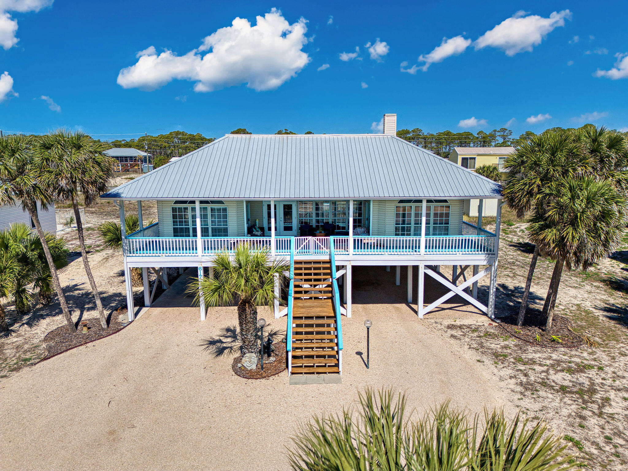Charming 4BR/2BA first-tier beach home with Gulf views and a private pool! Enjoy coastal living with a bright, open layout, quartz kitchen countertops, large island, wet bar with ornate sink, built-in bookcase, and wine storage. Each bedroom features wood floors, exterior access, and natural light. Relax on the spacious front porch or in the shaded pool area. New roof for added peace of mind. Just steps from the beach, this well-maintained retreat is perfect as a vacation home, rental investment, or full-time island escape.