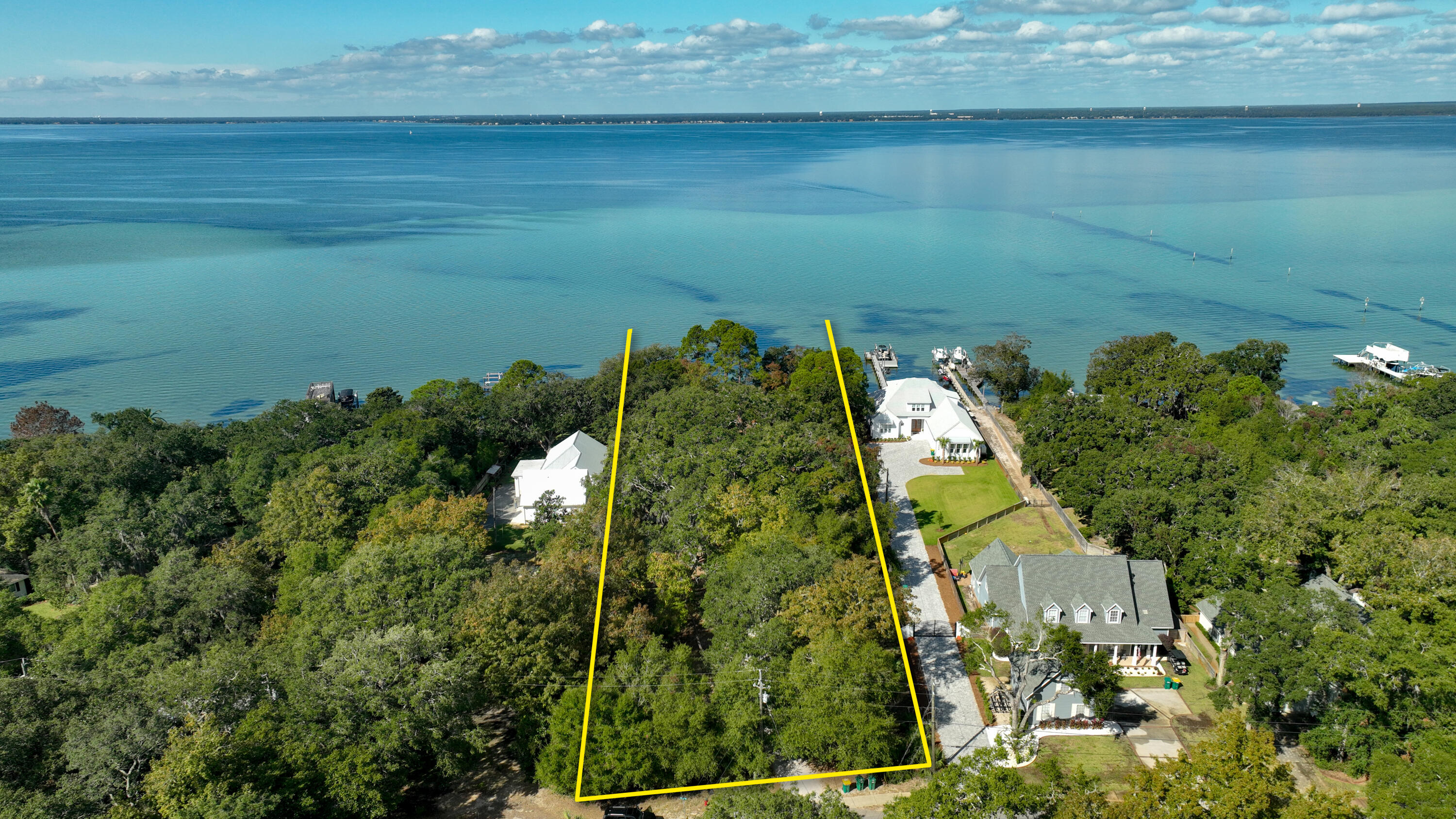 **NEW LISTING** NO HOA! Extraordinary 1.4+ acre parcel expanding 134' along the scenic shore of the Choctawhatchee Bay in Destin, Florida!This quintessential old Florida property contains (3) dwellings, all constructed in 1945, while the indigenous landscape provides a fabulous canopy of legacy trees gracing the homestead. This rare waterfront parcel offers a breathtaking view corridor across the beautiful bay waters, which will make a phenomenal family compound either renovating the existing, nostalgic cottages or building a custom home and carriage home. The expanse of this parcel would easily accommodate a large house footprint, all on one level. Please inquire to coordinate a private showing. Please do not trespass on property without... the listing agent(s) accompanying.