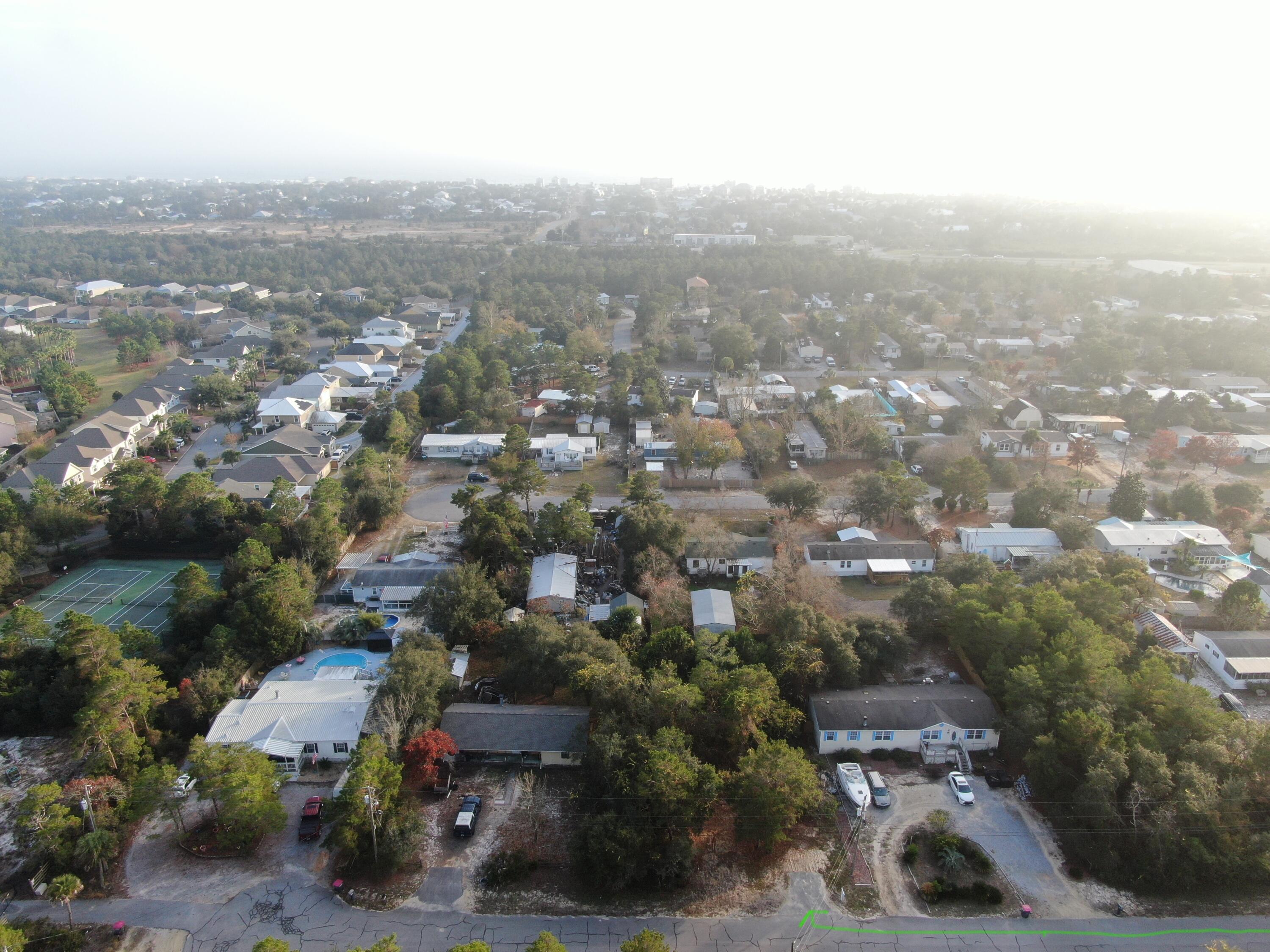 Come quickly and see a this quarter acre wooded lot on the West end of the Panama City Beach right across from Lake Powell. This lot is on a quiet dead end street and is the perfect place to build any home. It is conveniently located with shopping, restaurant, and the many activities of Panama City Beach. You can also hop over to all that 30A offers. NO HOA'S!! Some of the front of the lot has already been cleared and use to have a dumpster sitting where the paved entrance begins.