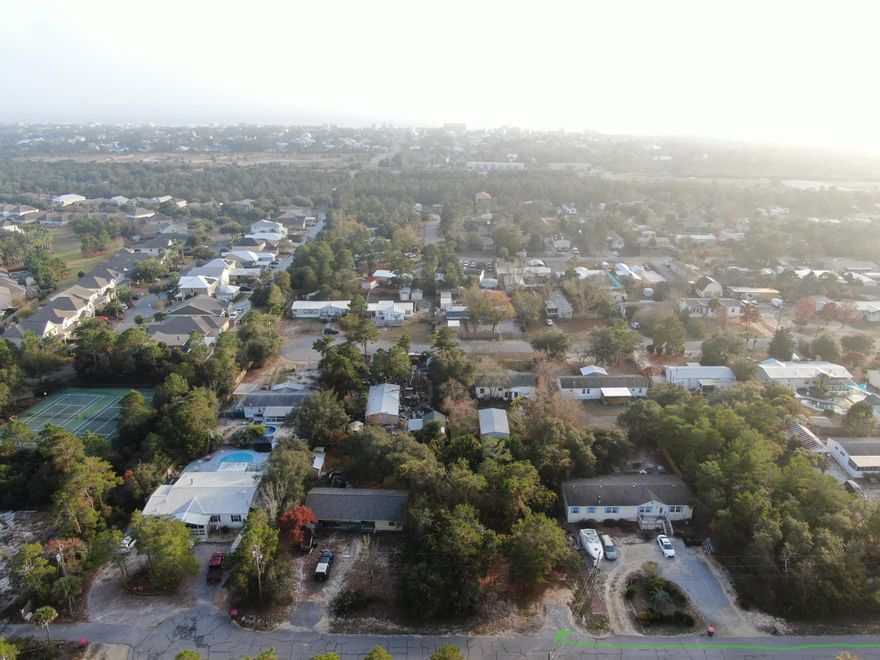 Come quickly and see a this quarter acre wooded lot on the West end of the Panama City Beach right across from Lake Powell. This lot is on a quiet dead end street and is the perfect place to build any home. It is conveniently located  with shopping, restaurant, and the many activities of Panama City Beach. You can also hop over to all that 30A offers. NO HOA'S!!  Some of the front of the lot has already been cleared and use to have a dumpster sitting where the paved entrance begins.