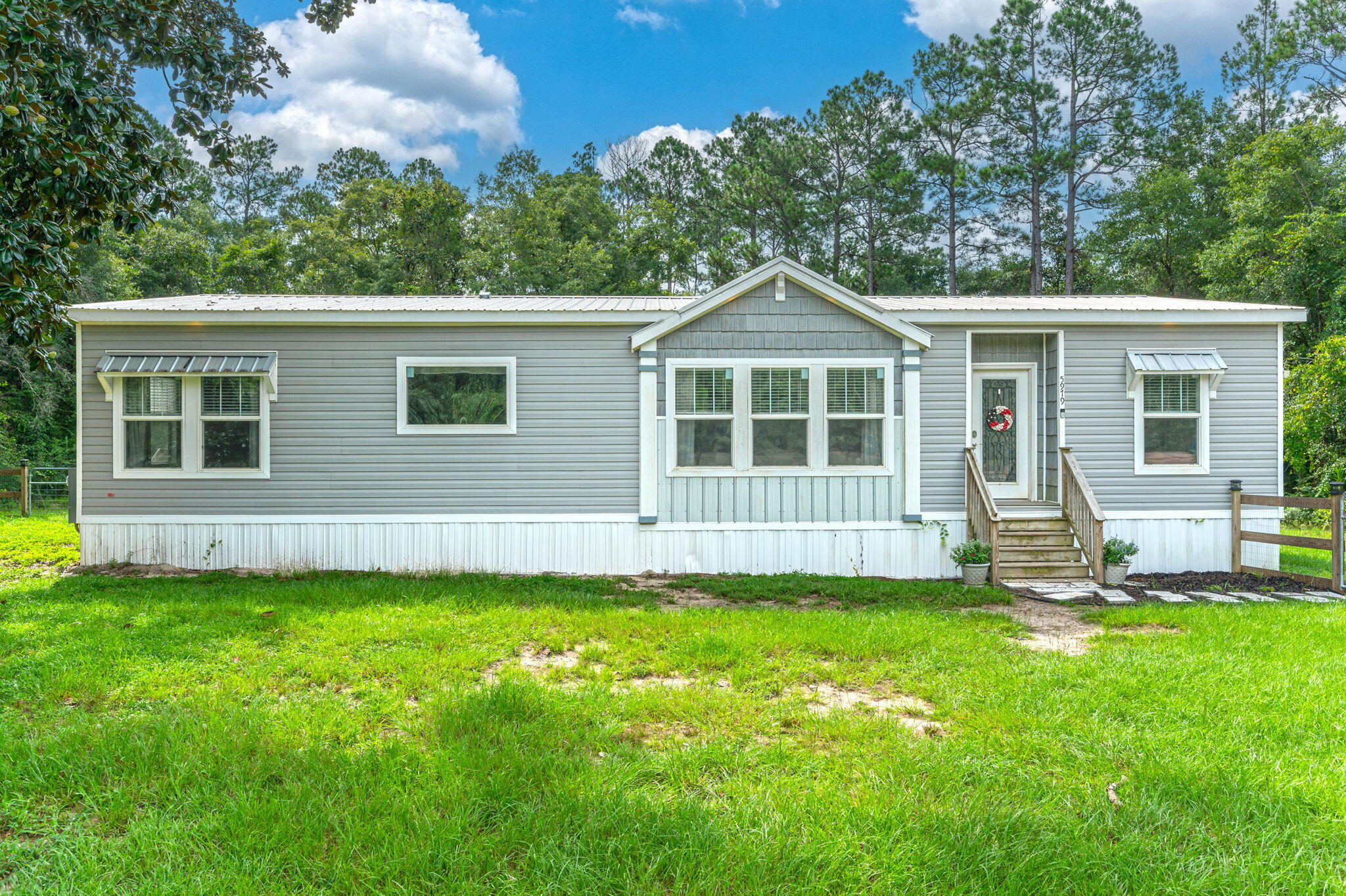 Welcome home! This beautiful 3 bedroom, 2 bathroom home sits on 3 acres surrounded by lush trees and greenery. The open floor plan creates a warm and comfortable atmosphere perfect for hosting guests. The kitchen boasts gorgeous white cabinets, a large farmhouse style sink, builtin shelving, a breakfast bar, ample storage space, and so much more! The master bathroom features a garden tub and separate shower, a double vanity, and beautiful cabinetry. Enjoy summertime in the well-maintained above ground pool in the backyard. The shed also conveys with the property. Home was manufactured by Clayton homes and is an Abigail model purchased in 2019. Schedule your showing today!