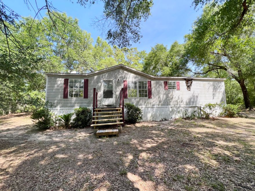 This 3 bedroom 2 bath REO Mobile Home is just under 1500sf and rests on 0.65 acres. Home has split bedroom design, indoor laundry, vaulted ceilings in LR, and tons of potential. Country living that is a short distance to interstate and beaches of Panama City Beach. A must see to appreciate the opportunities here.