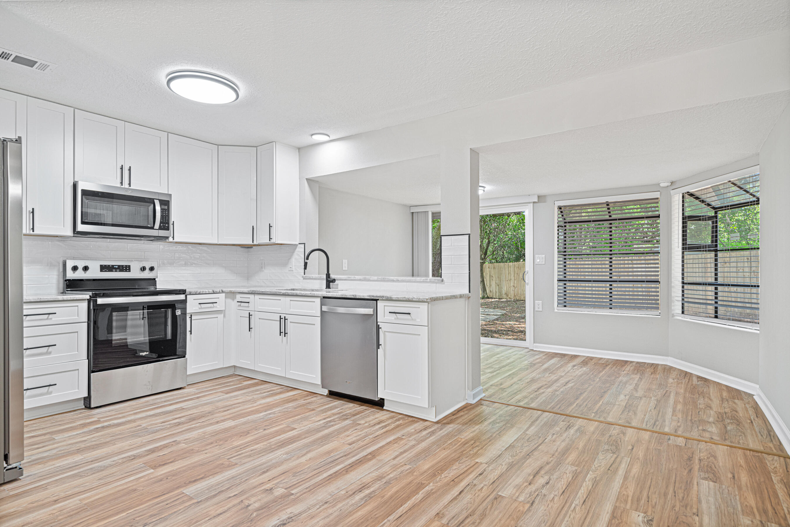 Welcome to 7653 East Bay Blvd., Navarre - A Rare Find on 1.2 Acres!This beautifully updated 3-bedroom, 2-bath home offers 1,600 square feet of comfortable living space. Nestled on a spacious 1.2-acre lot, this property is a true gem!Home Features:✔ Newly Updated Kitchen - Stainless steel appliances, stunning granite countertops, and modern cabinetry✔ Fresh Flooring Throughout - Laminate in main areas, luxury vinyl in baths, and cozy carpet in bedrooms✔ Recently Painted Inside & Out - A fresh, modern look throughout the entire home✔ Upgraded Baths - New vanities, mirrors, lighting, and fixtures✔ New Interior Doors - Adding a touch of style and functionality. 2016 roof, 2023 ac, 2025 hot water heater, 2025 septic installation in progress