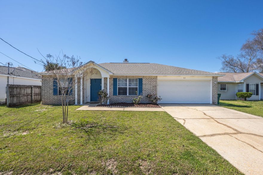 Welcome to 83 Stowe Rd in Mary Esther, Florida. This location is ideal for active duty and DOD personnel working at Hurlburt Field, as it is conveniently situated just west of the base. A short 13-minute drive will take you to Navarre Beach, where you can enjoy some of the world's best beaches at your leisure. For shopping and dining, Elevate Navarre offers options like Publix, Starbucks, and Buffalo Wild Wings. Heading east to Fort Walton Beach, you'll find additional choices such as Target, Santa Rosa Mall, and the upcoming Academy Sports. No matter which direction you choose, there's something nearby to enjoy. This home offers a practical living space with laminate wood flooring and an electric fireplace with a stone surround. The vaulted ceiling adds a sense of openness. The kitchen is equipped with stainless steel appliances and a convenient breakfast bar. The primary bedroom features a walk-in closet, double vanity, and a tub/shower combo. The split bedroom floorplan provides privacy, and additional features include a 2022 gas water heater, a 2021 roof and a privacy fenced backyard. 