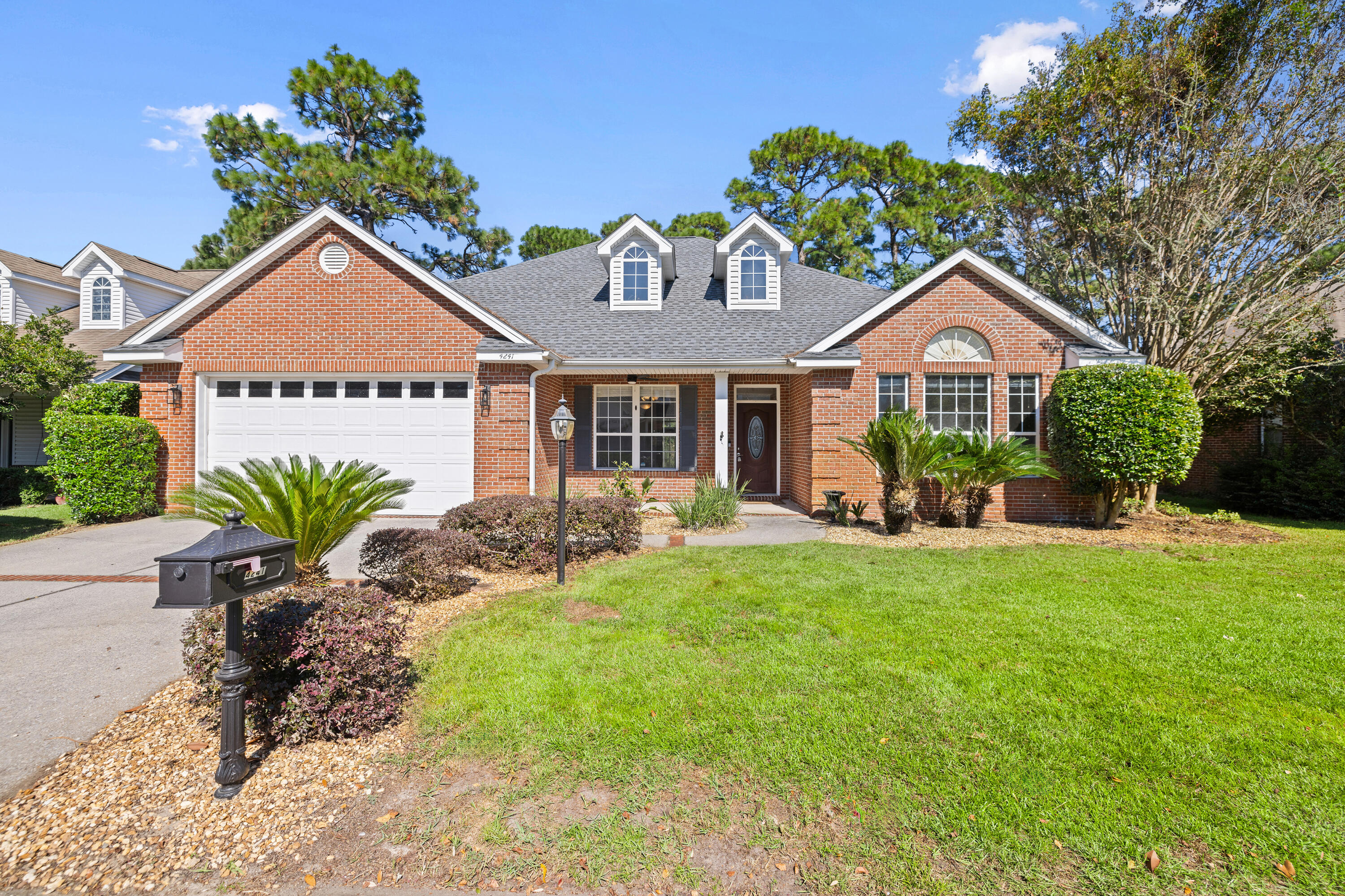 Experience tranquil living in this beautiful single-story, 3-bedroom, 2-bath home located in the exclusive gated community of Magnolia Plantation at Bluewater Bay. With 2,339 square feet of living space, this home offers both comfort and style. The kitchen is a standout feature, complete with a Viking gas cooktop/oven, oak cabinets, stainless steel appliances, black granite countertops, and a center island--perfect for culinary creations. Multiple living spaces include a large living room with a gas fireplace, a dining room adorned with hardwood floors, and a sun-drenched bonus/sunroom.The neutral-toned interior is complemented by luxury vinyl flooring in the master bedroom and fresh carpeting in the guest rooms.