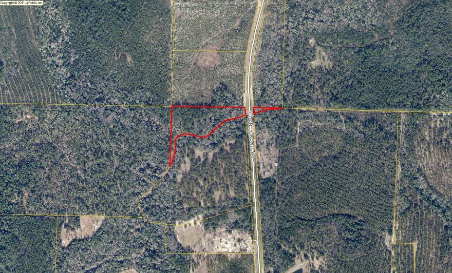 Approximately 6 acre parcel bordering a creek on a county paved road. Survey available