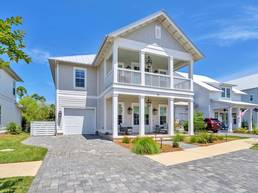 Tucked within the serene Cottage Grove community, this beautifully designed 3.5-bedroom, 3.5-bathroom home offers an exceptional blend of modern luxury and Southern charm. Built in 2020 and surrounded by state forest and preserve, it provides both privacy and proximity--just a mile from the beach with a new multi-use path leading directly to Gulf Place on 30A. Inside, 10-ft. ceilings and engineered hardwood floors set the stage for refined coastal living. The gourmet kitchen is a chef's dream, featuring a large island with ample storage, KitchenAid commercial-style appliances, and a wine refrigerator with custom cabinetry in the dining area. A nearby powder bath featuring tile flooring adds convenience. Plus a dedicated home office with a single bed offers flexibility, while designer lighting and quartz countertops elevate the space. Upstairs, the spacious primary bedroom offers a luxurious tile shower with dual vanities, and a large walk-in closet. The suite opens to a private balcony overlooking the tranquil community pond, which is a perfect spot for morning coffee and stunning sunsets. The second floor also offers another guest room with ensuite bathroom, and a huge bunk room with four built-in bunks, plus another guest bathroom. The screened porch with a summer kitchen extends the living space outdoors, overlooking a spacious backyard with an outdoor firepit and plenty of room for a pool. Notable additions include an epoxy-finished garage floor, surround sound speakers and security system. Move-in ready and sold furnished with a few exclusions, this home also includes a golf cart for effortless coastal cruising. With a gated entrance, community pool, and the opportunity for 30+ day rentals, Cottage Grove offers a peaceful retreat minutes from everything 30A has to offer. 
