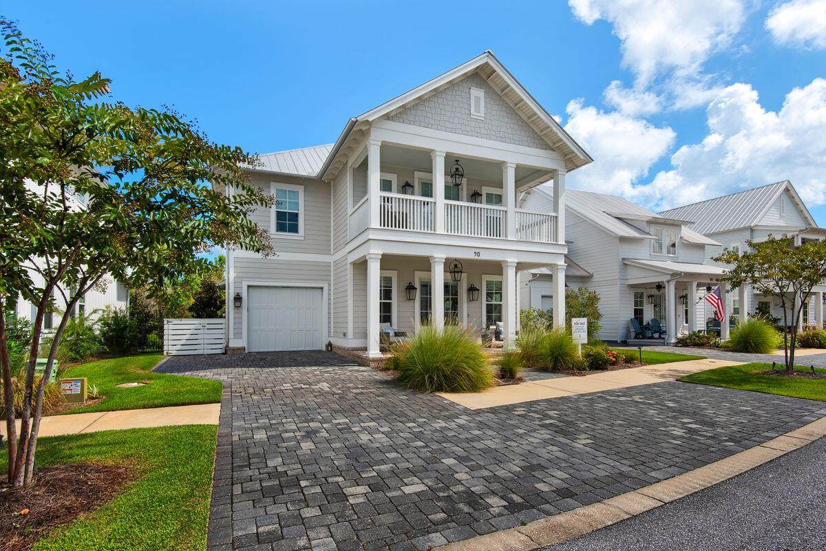 Tucked within the serene Cottage Grove community, this beautifully designed 3.5-bedroom, 3.5-bathroom home offers an exceptional blend of modern luxury and Southern charm. Built in 2020 and surrounded by state forest and preserve, it provides both privacy and proximity--just a mile from the beach with a new multi-use path leading directly to Gulf Place on 30A. Inside, 10-ft. ceilings and engineered hardwood floors set the stage for refined coastal living. The gourmet kitchen is a chef's dream, featuring a large island with ample storage, KitchenAid commercial-style appliances, and a wine refrigerator with custom cabinetry in the dining area. A nearby powder bath featuring tile flooring adds convenience. Plus a dedicated home office with a single bed offers flexibility, while designer lighting and quartz countertops elevate the space. Upstairs, the spacious primary bedroom offers a luxurious tile shower with dual vanities, and a large walk-in closet. The suite opens to a private balcony overlooking the tranquil community pond, which is a perfect spot for morning coffee and stunning sunsets. The second floor also offers another guest room with ensuite bathroom, and a huge bunk room with four built-in bunks, plus another guest bathroom. The screened porch with a summer kitchen extends the living space outdoors, overlooking a spacious backyard with an outdoor firepit and plenty of room for a pool. Notable additions include an epoxy-finished garage floor, surround sound speakers and security system. Move-in ready and sold furnished with a few exclusions, this home also includes a golf cart for effortless coastal cruising. With a gated entrance, community pool, and the opportunity for 30+ day rentals, Cottage Grove offers a peaceful retreat minutes from everything 30A has to offer.