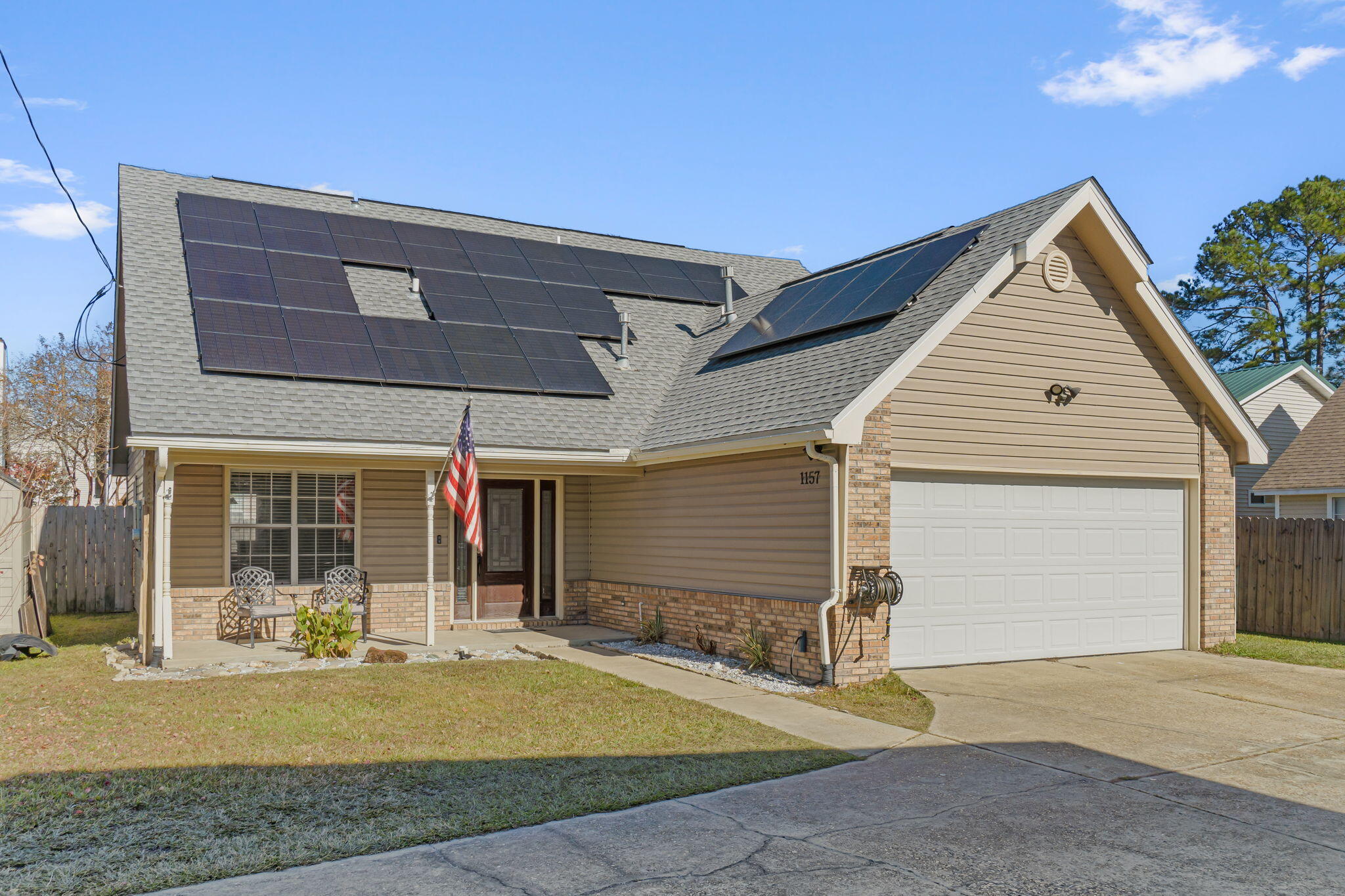 *Enjoy huge utility savings with paid off solar panels!* Located at the very end of a cul-de-sac in Fort Walton Beach (with no HOA!), this four-bedroom, two and a half-bathroom home is sure to charm. Pull in the long driveway and appreciate the well landscaped yard and the adorable covered front porch. With wood-laminate and tile flooring throughout the entire first floor of this home it also boasts a formal dining room with custom built-ins, a well appointed kitchen with breakfast nook open to the living room, a first floor master suite, a half-bath and an interior laundry room. The kitchen features stainless steel appliances, granite counters, and a closet-style pantry. You'll love relaxing in the main living area, where you'll find high vaulted ceilings and a fireplace. The owner's suite has hard surface floors a walk-in closet and ensuite bath. The bathroom spares no desire with large tile flooring, a double vanity, linen closet and a garden tub/shower combo. At the top of the stairs, a carpeted large landing can be used for almost anything your imagination desires - a playroom, an office, a lounge area or a reading nook. Off of the landing, the upstairs features three more spacious bedrooms and a hall bathroom with a tub/ shower combo, double vanity and laminate flooring. Outside you'll find a fully fenced in backyard with a storage building. Convenient to Eglin Air Force Base, Hurlburt Field, Ft. Walton Beach Medical Center, and the downtown area full of boutique shopping and nightlife, this home is perfectly situated for the area. Welcome home!