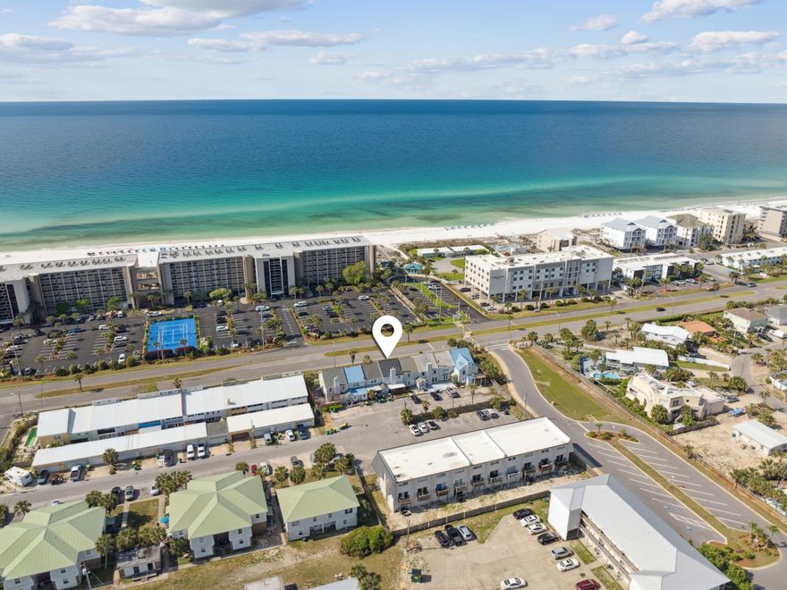 Located less than 200 feet from the sugar-white sands of the Gulf and a public boat dock, this beautifully updated townhome on Okaloosa Island offers the perfect blend of beachside living and smart investment potential.Inside, a freshly painted interior sets a bright and welcoming tone, with coastal-inspired hues and stylish finishes throughout. The open living area features charming shiplap walls and durable luxury vinyl plank flooring that flows seamlessly through the dining area into the well-appointed kitchen. Here, a full suite of white cabinets and appliances offers ample storage and prep space--perfect for whipping up meals before a day at the beach.Upstairs, three spacious bedrooms and two full bathrooms (including a private ensuite) provide comfortable accommodations, all thoughtfully styled with relaxing coastal tones and additional shiplap accents. The primary suite even enjoys serene water views, adding to its tranquil retreat feel. 

Step outside to your private fenced courtyard, where a large deck, cozy fire pit area, and newly planted palm tree create an inviting space for outdoor dining, entertaining, or simply relaxing under the stars. Both front and rear decks have been recently repainted for added curb appeal.

Additional upgrades include a new shingle roof, coastal-grade HVAC system, updated electrical panel, modern fixtures, and renovated bathrooms. This turnkey property also offers private parking, coastal furnishings, smart TVs in every room, and no HOA fees.

With unbeatable proximity to the beach, public boat access, restaurants, shops, and local transit, this move-in-ready home is ideal as a primary residence, vacation escape, or high-performing rental.