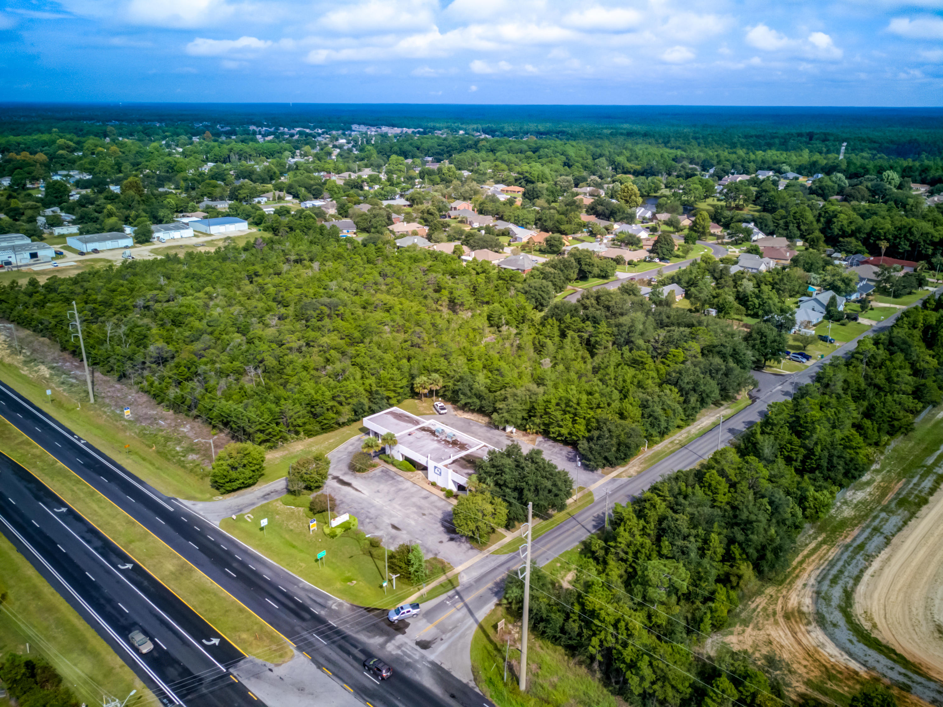 Exceptional corner commercial site containing a former bank building measuring approximately 4,438 SF. The parcel measures approximately 200' along Highway 98 and 200' in depth along Rosewood Drive, totaling approximately .92 acres. Zoning is as follows: (HCD) Highway Commercial Development District. The adjacent 9.5-acres is also available under a separate listing, MLS 806170.Buyer must very all information and specifications.