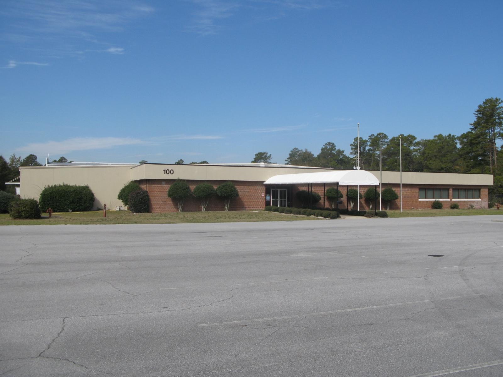BANK OWNED, Former Russell Mills building. Approx. 17,000 sqft is offices of various sizes, large meeting rooms, and break room. Approx. 11,700 sqft is open heated/cooled former manufacturing area. Has Heavy electrical and raised loading dock with 3 garage doors. Rear of the propery is fenced, front of the building is paved parking. A 930 sqft freestanding metal storage is in the back fenced area. The front approx. 17,000 sqft is occupied by a church and owner can give a 60 day notice to vacate. Located next to Twin Cities Hospital. Property is sold ''as is, where is, with all faults'', without repairs.