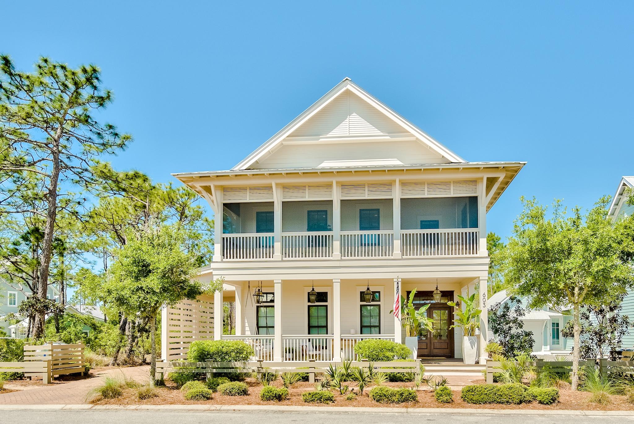 This custom-built WaterColor home offers 4,082 square foot of coastal living with 7 bedrooms and 6.5 bathrooms. Home has been redone including exterior paint. The main house features 5 bedrooms and a drive through porte-cochere leading to the carriage house that features 2 bedrooms plus a kitchen and laundry. The oversized porch features beautiful Cumaru wood decking, tongue and groove wood ceilings, copper light fixtures and magnificent double mahogany doors. Stunning custom interior details include wide plank Ash wood floors, shiplap walls, custom molding and cabinetry throughout. The first floor offers a free-flowing layout with a combination of transom-topped windows and French doors.