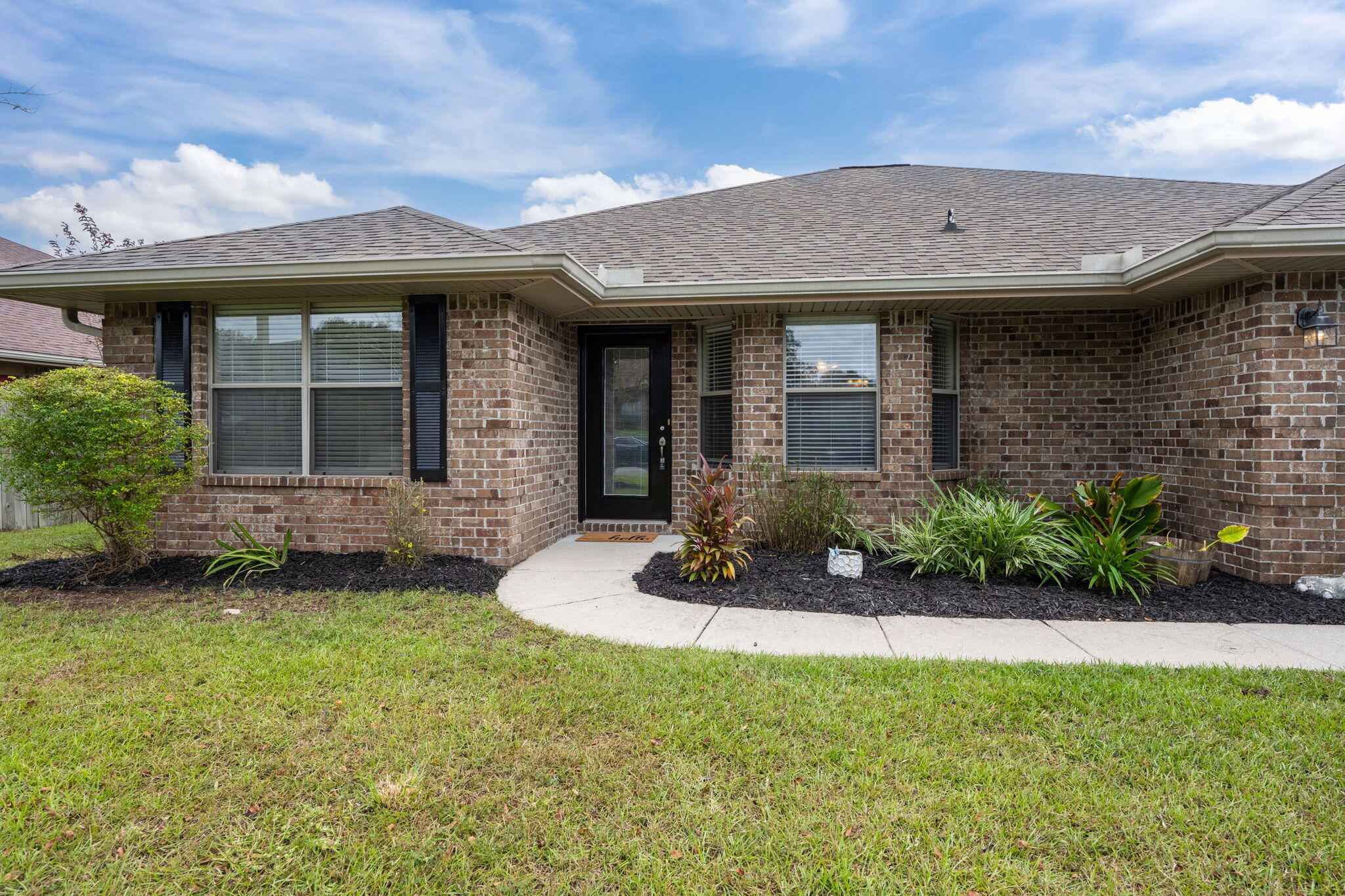 Welcome to your new home at 2826 Shoni Dr. in beautiful Navarre! This stunning all-brick residence features a split floor plan with 4 bedrooms and 2 full bathrooms, perfect for anyone seeking extra space.As you enter, you'll be greeted by an open and inviting layout that seamlessly connects the dining, kitchen and living area. The heart of the home is the spacious kitchen, boasting an island and stainless steel appliances. Step outside to your private deck, where you can relax or entertain while enjoying the serene surroundings. Located in a peaceful neighborhood, you're just minutes away from local shops, restaurants, and the beautiful beaches of Navarre. Schedule your showing today!