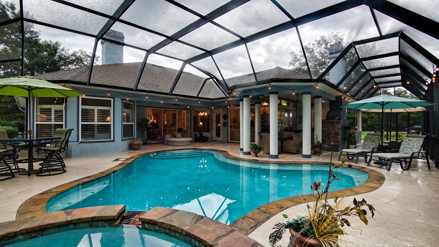 ABSOLUTELY STUNNING CUSTOM BUILT HOME! This Florida Oasis is a showpiece both in and out! Located at the T on the 15th Hole @ Hidden Creek Golf Club, this home is a must see. Upon entering the you will notice the 12' ceilings throughout the main living area, Trey ceilings with accent lighting, gorgeous crown moldings and architectural details. This home features 3 spacious bedrooms, 3 & 1/2 baths, den/office, formal dining room & living room w/wet bar offering a wine fridge & ice maker, perfect for entertaining guest. A spacious kitchen with a 5 burner gas cooktop, wall oven, warming drawer & custom cabinets w/pullouts will surely please the chef in the family. The spacious family room offers built ins and a wall of sliding glass doors to bring the outside in. Click ''More'' for addt detai The Master Retreat located on the opposite side of the home offers bamboo floors, plantation shutters, sitting area overlooking the pool and both walk in closets have skylights for natural lighting. The master bath features separate vanities, private water closet, soaking tub and walk in shower with dual shower heads.  Wether you need extra space to prep for entertaining guest or a great indoor workspace for crafts etc., this home offers a large workroom which has tons of storage space to include closets and a wall of cabinets in addition to the under window storage.  This also acts as the laundry room and there is a separate fridge, dishwasher and sink, perfect for prepping large parties if you desire.  All three walls of glass sliding doors in the main living areas slide all the way open to bring the outdoors in.  This home is perfect for entertaining because you have the large screen enclosed gunite pool with salt system and spill over heated spa, gas fireplace, outdoor gas grill, outdoor shower and with over 700sf of covered back patio area as well as the open patio area (all of which is screened) the options are endless! Although on the course there are beautiful oak trees that allow for some privacy.  The seller has taken immaculate care of this home.  The 2 HVAC systems were replaced in 2018, hot water heater replaced in 2019, there is a whole house water softener system and it was replaced in 2019, super quiet dishwasher replaced in 2017, the exterior was painted with the top of the line stucco paint from Sherwin Williams in 2018 and the entire pool and spa was resurfaced in 2016 to include the tile and stone edging.  The pool pump was also replaced in 2018.  This custom built Arthur Rutenberg home is gorgeous and definitely one to call home.  For a private tour contact your agent today.