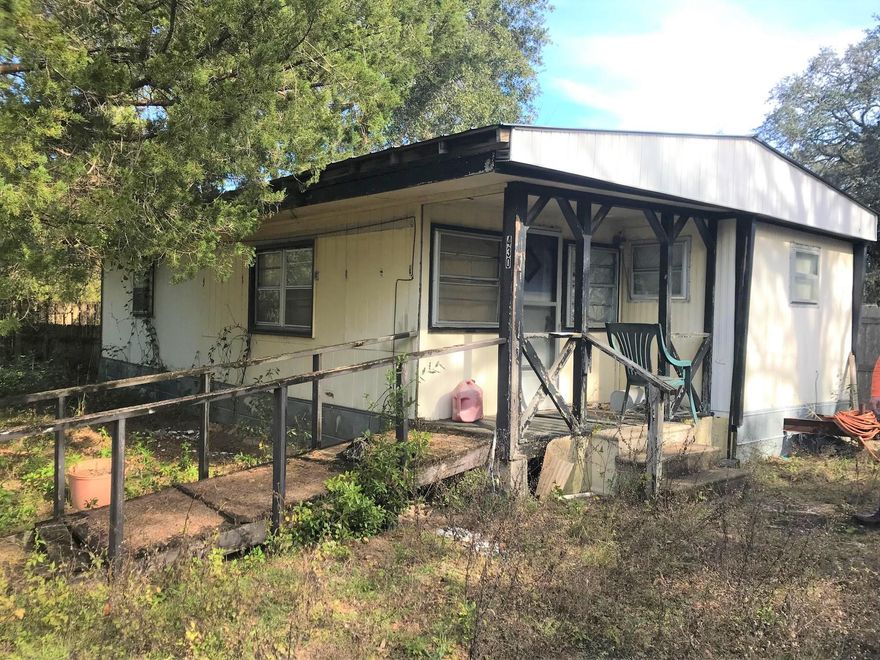 1/3 acre lot in the heart of Freeport with old MH on property. The MH is in need of work but does have newer metal roof, free of leaks and could be fixed up for the right buyer. Would also make a great home site as well. Great location and right across from the entrance to Canopies of Freeport. The metal storage building towards the from at N Jackson St. will be removed but the Katrina cottage behind the MH will stay.