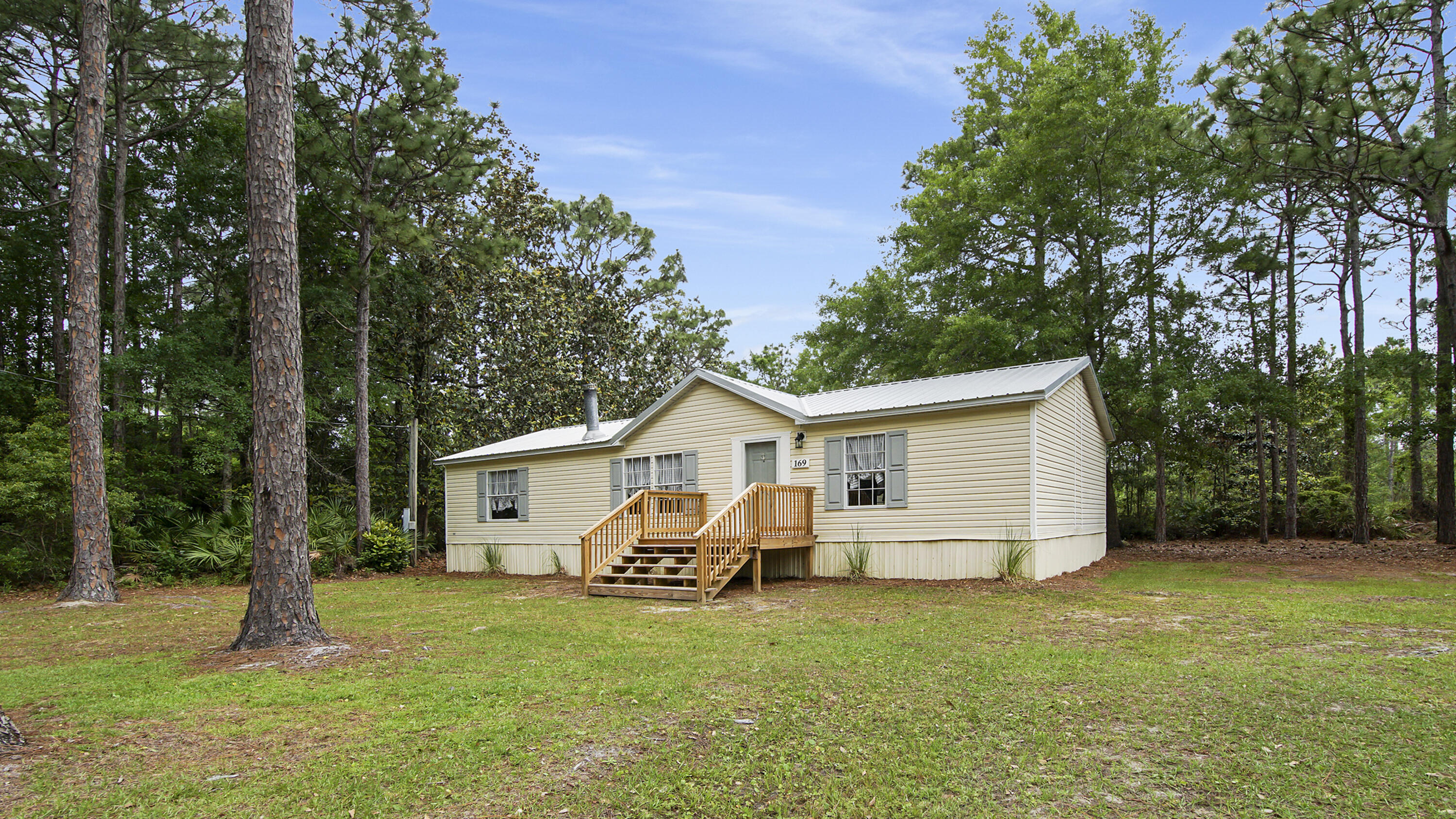Discover the perfect blend of comfort and convenience in this delightful mobile home in South Walton's heart! Nestled on a spacious half-acre lot, this property offers privacy and plenty of room to roam. Whether you're an outdoor enthusiast or just love a cozy, move-in-ready space, this home is sure to impress. Centrally Located: explore all the nearby parks and attractions with ease. Boater's Dream: The nearest boat ramp is a few miles away, making it effortless to launch into the bay for a day of saltwater fishing, enjoying the scenic waters, or a trip to Crab Island. Move-in ready: This three-bedroom, two-bath home has a new metal roof, hot water heater, fresh paint throughout, new fixtures, and a deck in 2024. An additional 400 square feet of living space is in an adjacent building. There is no HOA. All measurements are approximate, and Buyer/ Buyer's Agent is to verify all information and dimensions deemed important. This residence is in a Flood Zone.