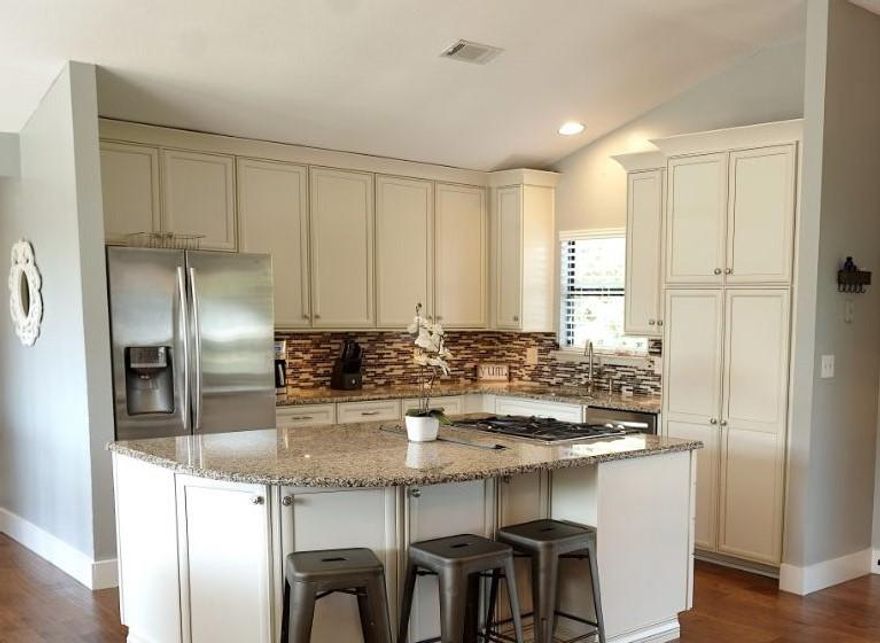 Huge price reduction! Bring your buyers! Location is key with the beach, bay, food and fun all within a short golf cart ride away . This beautifully updated spacious home would be an ideal addition to your investment portfolio, or the perfect place to call home.This home features two masters, one on the 1st floor, and one of the second floor each with their own en suite baths, and additional bedrooms and guest bath. This home provides a wide open floor plan with vaulted ceilings that is great for entertaining.The gorgeous granite island in the center of the kitchen steals the show, along with the details of soft close cabinets, hand scraped hickory floors, gas fireplace, and screened in back porch for relaxing after a long day. There are many practical benefits to this home as we