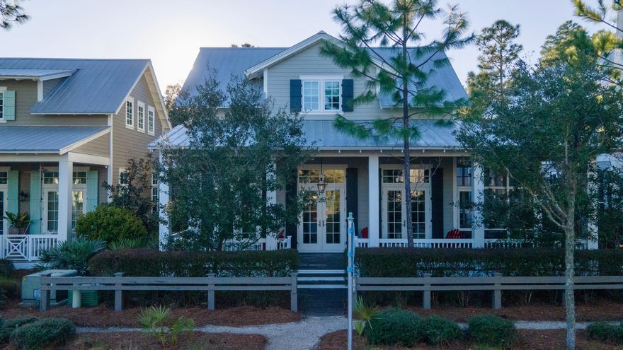 Highly sought after Romair Magnolia Plan in Phase 4 of Watercolor. The exterior of the home features beautiful porches with a screened side porch opening to the dining area, also a beautiful front porch running the entire length of the home.There are '5 parking spaces' plus a 'CARPORT with 2 spaces'. The centerpiece of the home is the living/dining/entertainment area which has tremendous volume with 12 foot ceilings. The kitchen mixes well with this area and includes icemaker, wine cooler, and free standing island. The master suite and an an office are located on the first floor. Moving to the second floor, there is 2 additional bedrooms with their own bathroom, plus a 4 bed bunk and half bath. There is also a loft/entertainment area which can also accommodate a set of bunk beds.