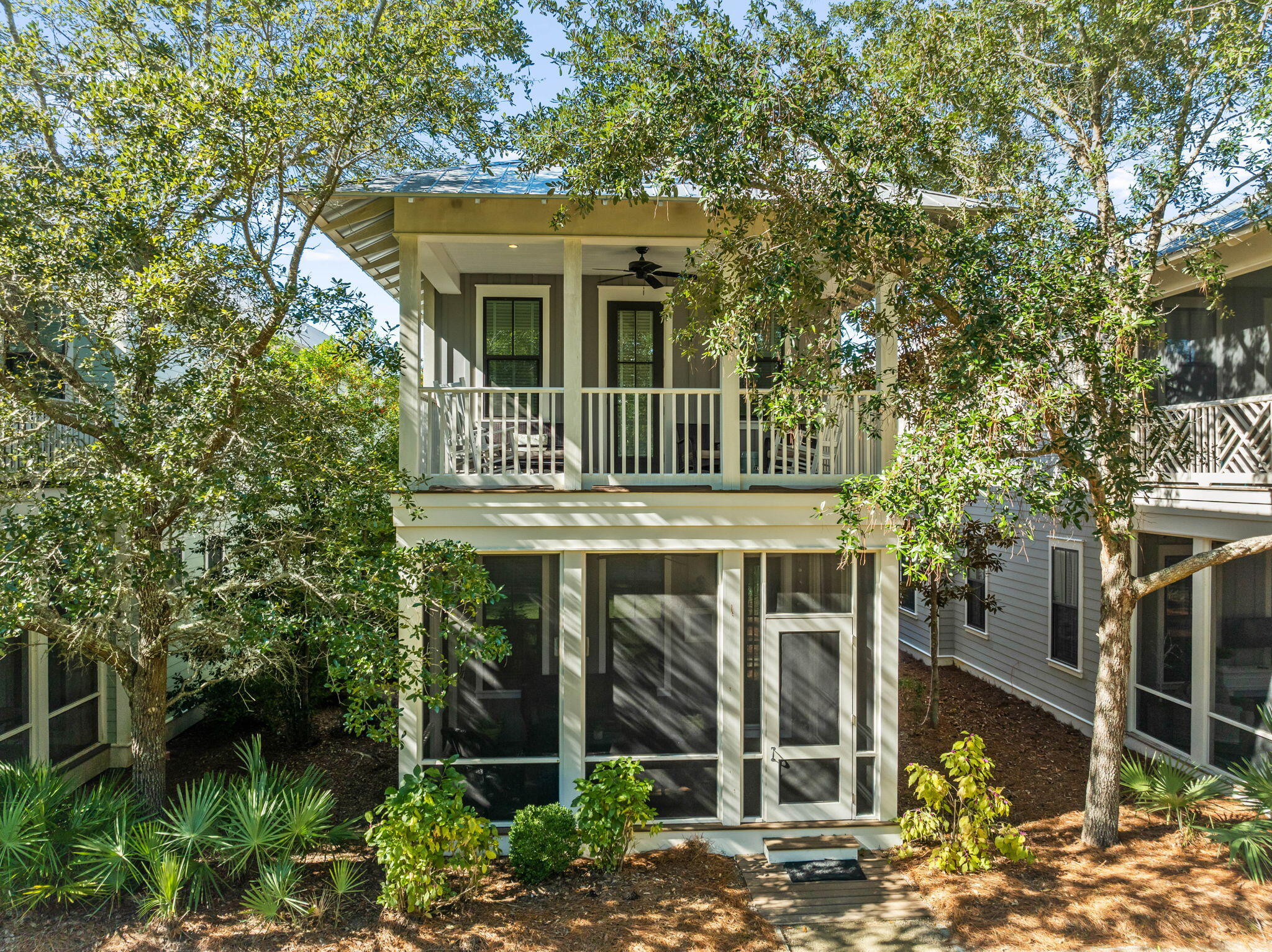 Nestled in the Crossings District of WaterColor, this stunning 5-bedroom home offers an unbeatable location to experience all that 30A has has to offer. The thoughtfully designed open floor plan on the main level seamlessly blends style and functionality. The galley kitchen, complete with stainless steel appliances, granite countertops, and ample workspace, is complemented by a breakfast bar with seating for three. Adjacent, the spacious dining area comfortably seats eight. The inviting living room features a plush seating area and access to a charming screened-in porch overlooking a serene green space. Additional first floor conveniences include a laundry room with high-efficiency washer and dryer, a dedicated office nook, and a powder room.This home  boasts abundant sleeping accommodations, including three luxurious king master suites, a cozy guest bedroom, and a spacious bunk room, ideal for hosting family and friends. Upstairs, the king master suite offers a tranquil private balcony with views of the pocket park and a comfortable seating area. A centrally located bunk suite with dual twin bunks shares a spacious hall bath with another built-in twin bunk area. An additional king master suite at the end of the hallway ensures privacy and comfort. The second floor also features a secondary living space perfect for unwinding or hosting extra guests.

The home is equipped with UV light sanitation in the air ducts and four carbon-filter HEPA air purifiers to ensure optimal air quality. 

WaterColor offers beautifully landscaped surroundings and convenient access to the Dragonfly Pool, complete with an outdoor fireplace, dining spaces, grills, and water features. Just a short distance from Seaside's shopping and dining, and access to the Gulf, this home provides an exceptional base for enjoying the best of 30A. Residents and guests of WaterColor can also take advantage of seven additional pools, Camp WaterColor, the Boathouse, the Beach Club, and other world-class amenities.