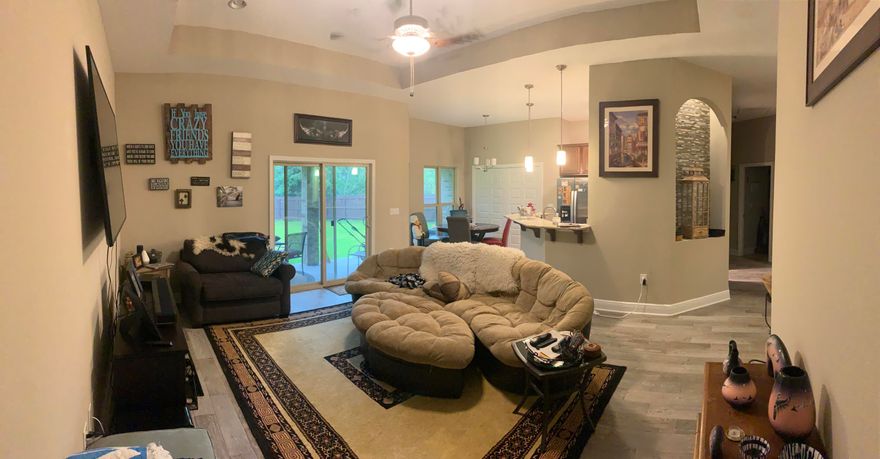 Gorgeous band new Flynn Built Home, Lived in less than a year, seller is needs smaller square feet home is too large for her. There are many beautiful features of this home. This is the ''Sawgrass'' home build. It features features an open design with large main living area boasting a trey ceiling with recessed lighting. The spacious kitchen has granite counters, tile backsplash, breakfast bar, dovetail drawers with soft close glides, and stainless steel range, microwave and dishwasher. The master bathroom is complete with a full tile shower with frameless glass enclosure and rain shower head, double vanities and garden tub with tile surround. The kitchen, breakfast area, foyer, bathrooms and laundry room all have 18''x 18'' tile floors. Also offering a Covered Patio to relax on, Full Ir