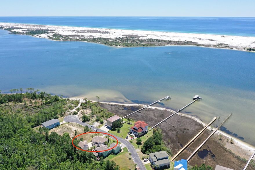 Incredible custom house located in Mary Esther's premier gated community! The sound views offered from this home are simply stunning. The main house consists of approx. 2,182 sq. feet, 3 bedrooms and 2.5 baths. The first floor of this Robert Fisher built home offers a large living room with rich hardwood flooring, soaring tall ceilings with tons of natural light, kitchen with stainless steel appliances and gas range, formal dining room, and master bedroom, all overlooking the sound! There is also a Florida Room off the kitchen which overlooks your own salt-water private pool. Above the detached garage is an 757 sq. foot guest house/mother-in law suite featuring a large living room, full kitchen with stainless steel appliances, and one bedroom and one bath as well as it's own recently