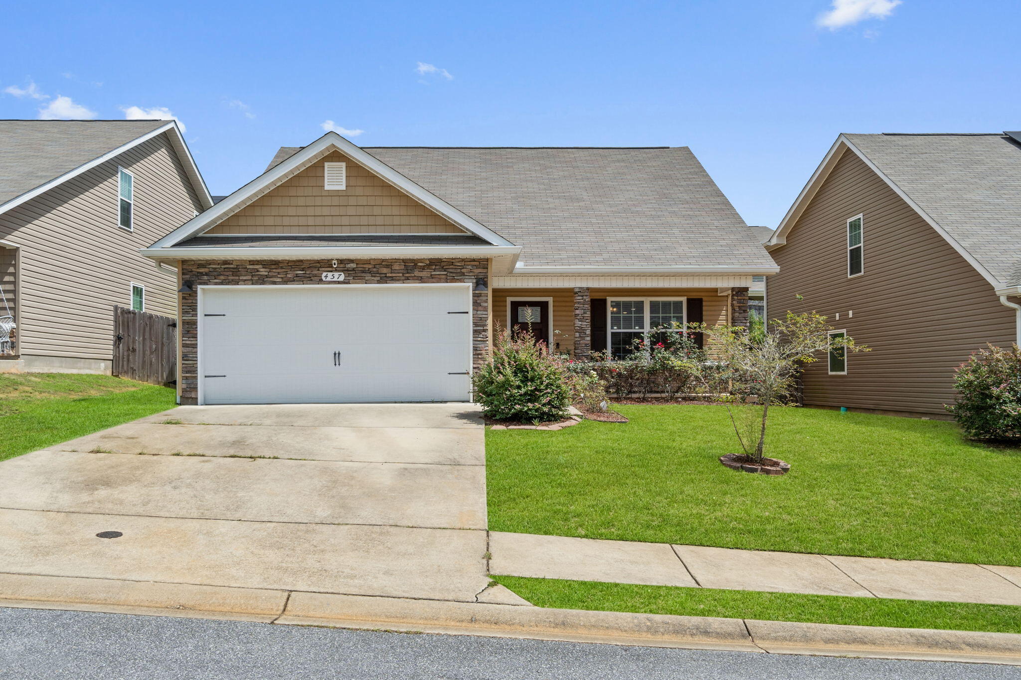Welcome to this fantastic FIVE bedroom home in Stillwell Estates! Walk past the newly sodded front yard to the covered front porch and into this fantastic open floor plan. Downstairs you'll find the master bedroom (along with a half bath off the dining space) and upstairs are 4 bedrooms with a shared bathroom with double vanities! The spacious living room features wood look luxury vinyl plank flooring that extends throughout the entire downstairs including into the kitchen and master bedroom with tile flooring in the bathrooms and interior laundry room which leads to the two car garage. The kitchen is well appointed with stainless steel appliances, white cabinets, drop down pendant lighting, and a separate pantry; and the eat-in dining space has a wood accent wall. Relax in your owner's