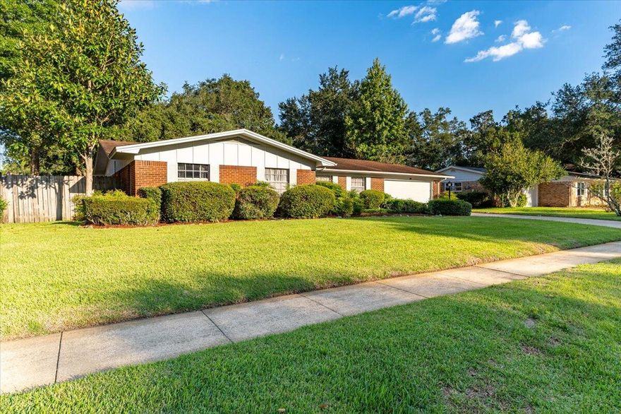 Welcome to this well-maintained home in the highly desirable Kenwood Neighborhood. This one owner home has thoughtfully been remodeled over the years to increase the size of the primary quarters, including a huge kitchen connected to the laundry room and a family room with wood-burning fireplace. This home has two full bathrooms, both with original tile, and three bedrooms in addition to a large primary bedroom with en-suite bath, sitting area/office and French doors leading out to the lush backyard. With a separate dining room and a formal living this home has plenty of space to spread out AND gather together. Plenty of parking with a 2-car garage and double large driveway for those game days and holidays. You'll enjoy the split floor plan as you retreat to the primary suite, complete with its sitting area/office space and a set of French doors leading out to the lush backyard. There's plenty of parking for summer bbqs and holiday gatherings in the double spaced, extra-long driveway. The lovely landscaping is nourished by an automated whole yard sprinkler system fed by a well water pump for lower water bills. Brand new attic insulation was installed in Summer 2024 for lower energy bills, and the recently replaced refrigerator, water heater and hvac system are also energy efficient. New light fixtures throughout the home and copper wiring updated to today's building codes will help save on your insurance costs. Call your favorite agent to set an appointment for viewing today.