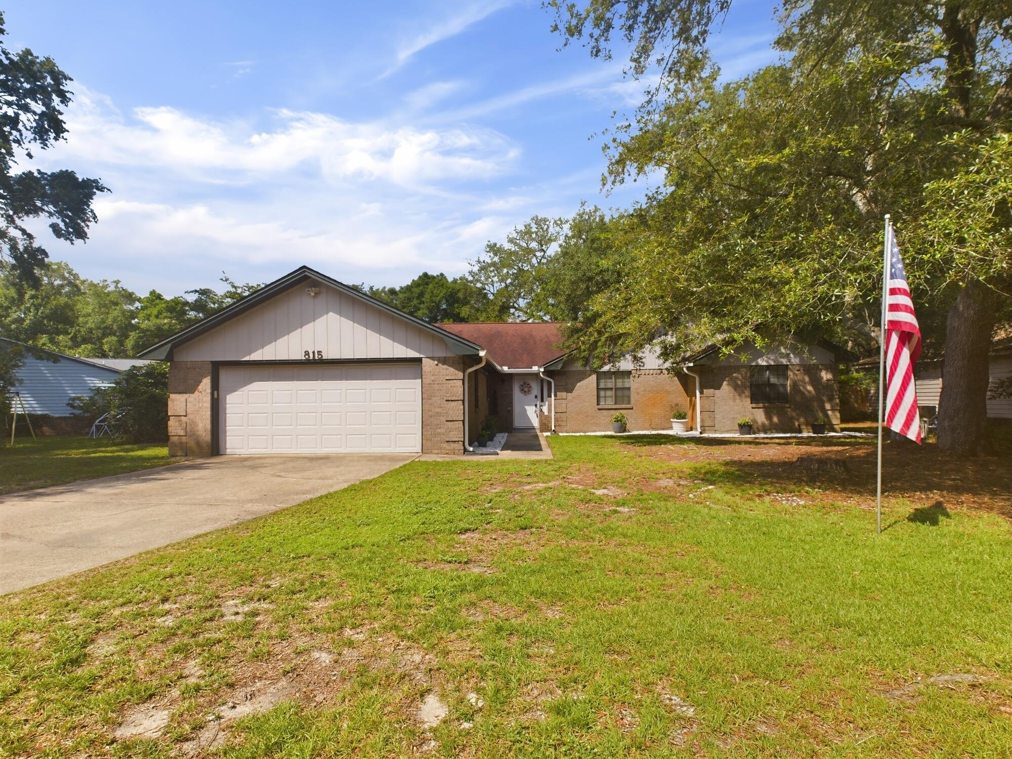 Welcome to this beautiful home in the desirable Bluewater Bay community. Situated on a spacious, 0.34 acre wooded lot, this 3-bedroom, 2-bathroom home spans 2183 square feet of comfortable living space. The roof was replaced in 2014, HVAC in 2012, HWH 2024. The kitchen is well-equipped with a cozy eat-in area, quartz countertops and tiled backsplash, and stainless steel appliances including a smooth top electric range. The Great Room features solid surface flooring, built-in cabinetry, and a charming brick fireplace with a heat-o-later, raised hearth and mantle, all under vaulted ceilings that add to the open, airy feel. French doors lead to an oversized Florida Room complete with heat and AC. This versatile space is perfect for a home gym, office, or play room. The backyard features