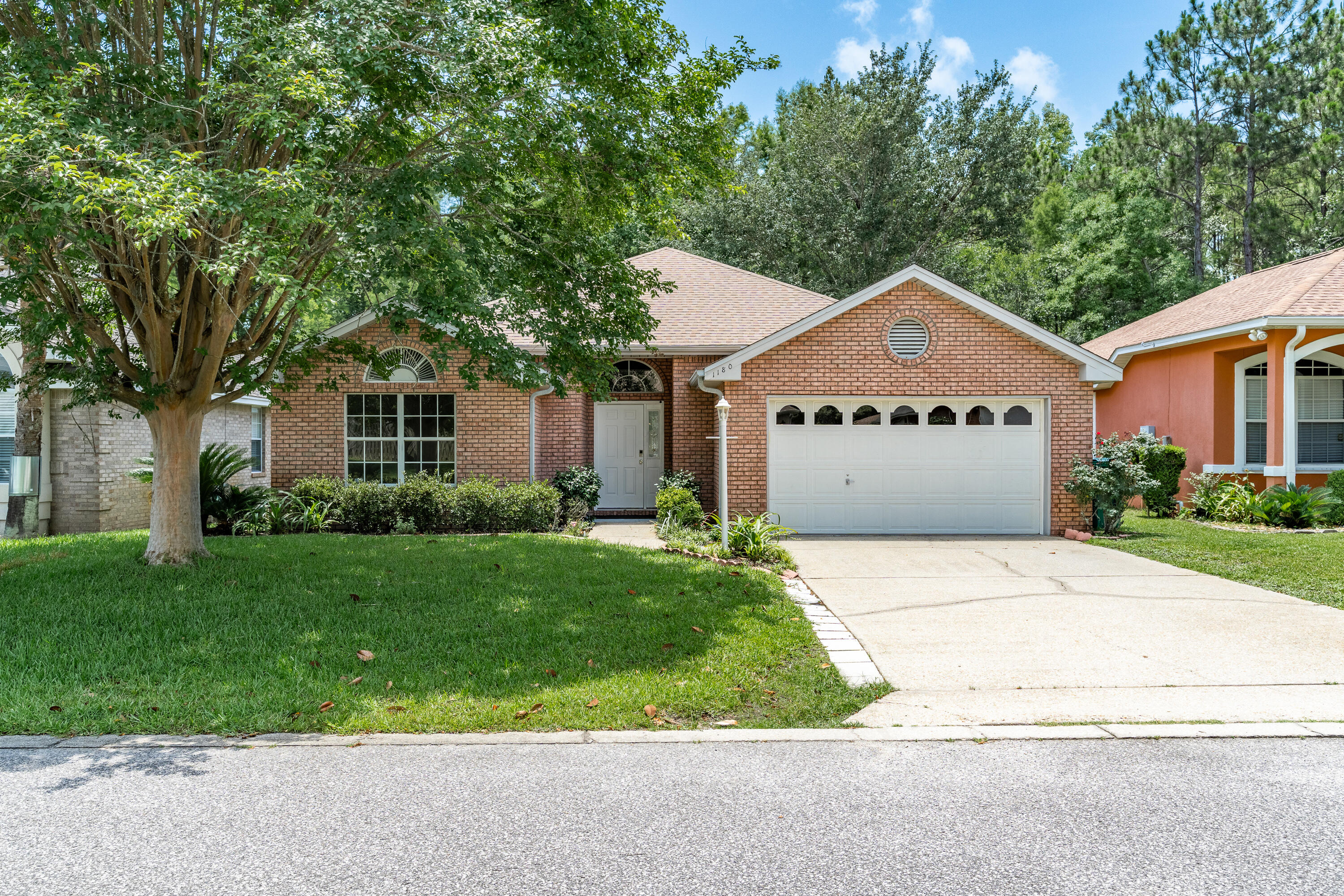 This home is situated on a beautiful lot amidst mature landscaping overlooking a creek in the neighborhood. Entering the home, you are greeted by the spacious living room with vaulted ceilings, built in bookshelves flanking the gas fireplace and beautiful French doors leading to a covered brick patio overlooking the serene backyard. The Primary Suite offers a walk-in closet with custom shelving & a fully remodeled en-suite with double vanity, shower, and stand alone tub to relax in. The kitchen is light and bright with plenty of cabinet storage and a pantry. The dining area boasts a view of the lush green backyard and there is additional seating at the breakfast bar. Close proximity to park, pickleball courts, and golf course. Roof 2019 HVAC 2020 Water Heater 2023