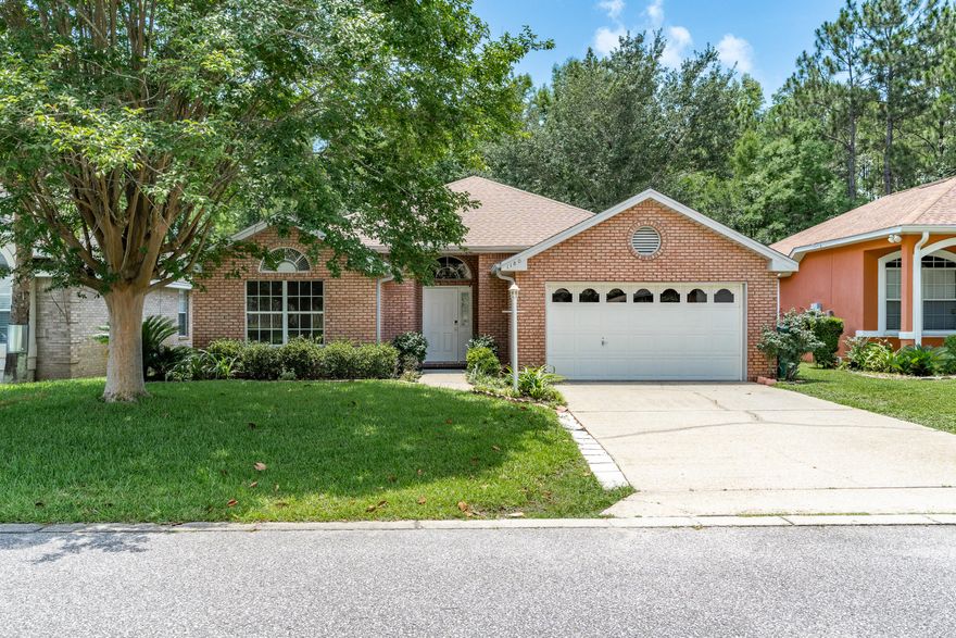 This home is situated on a beautiful lot amidst mature landscaping overlooking a creek in the neighborhood. Entering the home, you are greeted by the spacious living room with vaulted ceilings, built in bookshelves flanking the gas fireplace and beautiful French doors leading to a covered brick patio overlooking the serene backyard. The Primary Suite offers a walk-in closet with custom shelving & a fully remodeled en-suite with double vanity, shower, and stand alone tub to relax in. The kitchen is light and bright with plenty of cabinet storage and a pantry. The dining area boasts a view of the lush green backyard and there is additional seating at the breakfast bar. Close proximity to park, pickleball courts, and golf course. Roof 2019 HVAC 2020 Water Heater 2023
