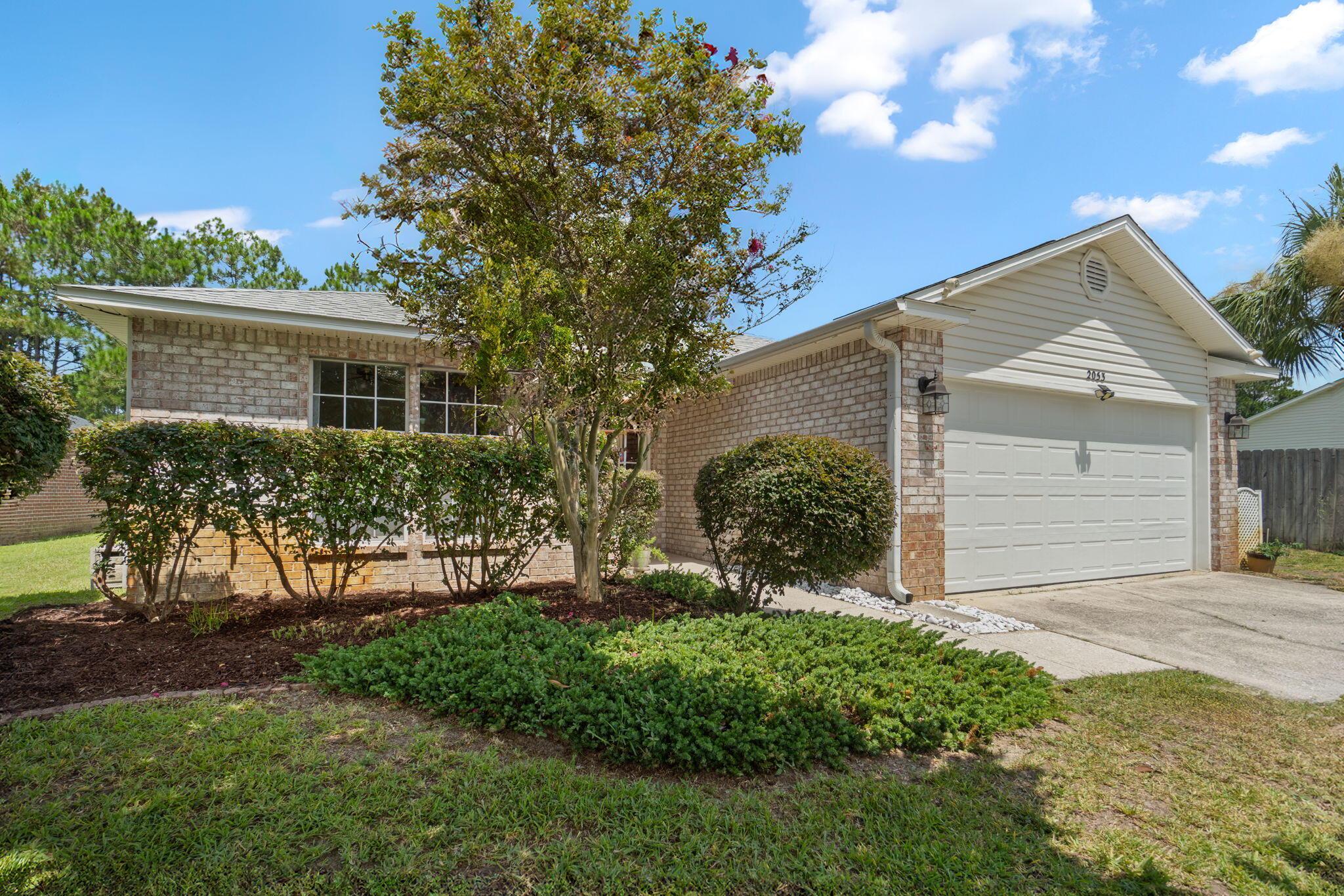 Welcome to this beautifully maintained, one-owner brick home in the desirable Hidden Shores neighborhood. This 3-bedroom, 2-bathroom home features a tastefully landscaped yard with mature greenery and even a producing fig tree! Have peace of mind with a 2021 roof, 2019 water heater, and 2018 HVAC. Step inside to an open floor plan with luxury vinyl plank flooring throughout - no carpet! The entire interior has been freshly painted, offering a clean and modern feel. The kitchen features white cabinetry with brushed nickel hardware, flowing seamlessly into the spacious living and dining areas. The owner's suite is a standout, with three added windows that fill the room with natural light and offer peaceful views of the well cared for backyard and lake. The ensuite bathroom includes double vanities, a soaking tub, walk-in shower, private water closet, and a massive 12'4" x 4'11" walk-in closet. Two additional bedrooms offer generous closet space and share an updated full bath. Enjoy relaxing on the back patio with serene views of the neighborhood lake and fountain. This home is move-in ready and truly turn-key, don't miss this gem in Hidden Shores!