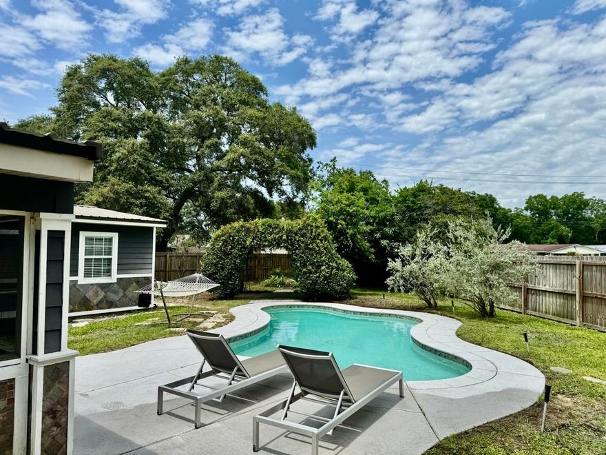 Discover a rare gem in the heart of Fort Walton Beach! As you enter through the charming carport, complete with attic storage, you'll be greeted by a cozy and inviting atmosphere. The elegant living room boasts built-in bookshelves.The chef's kitchen is a true showstopper, featuring ample prep space, abundant cabinets, gorgeous granite countertops, a spacious island perfect for family meals, and a gas stove with sleek stainless appliances. The formal dining area flows seamlessly from the kitchen, complete with a built-in bench.This home is ideal for entertaining, with a stunning screened patio leading out to your very own outdoor oasis. Enjoy the sparkling gunite pool, koi pond teeming with fish, and a finished shed perfect for storage or a hobby room. This home is move-in Ready!