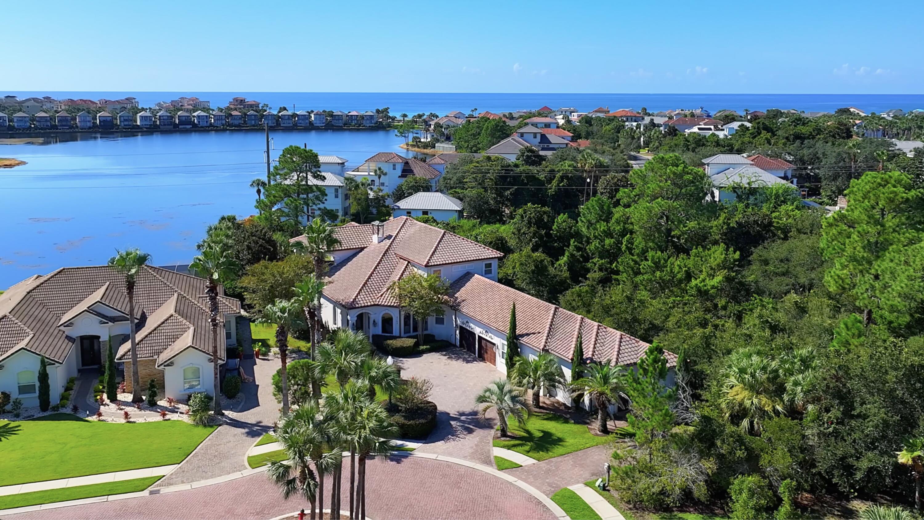 Beach living at it's finest in Destin! This seller is motivated and you won't find a better deal in Destiny East! This luxury home offers 5,278 sq. ft. of living space with a $30,000 buyer credit, bringing the price to just $395.89 per sq. ft.This magnificent 6-bedroom, 5.5-bath estate rests on one of the largest lots in Destiny East with approximately 120 feet of peaceful lake frontage. Built by a renowned local builder for his own family, the home showcases extraordinary craftsmanship, soaring ceilings, crown molding, hardwood and tile flooring, and thoughtful architectural details throughout. A private 800 sq. ft. guest suite enhances the property, complete with a full kitchen, 1.5 baths, bedroom, separate entrance, and its own driveway--perfect for extended family, guests, or rental flexibility.
The main home features an impressive waterfront master suite with sitting area (which is large enough to utilize as an office), spa-like bath and custom his-and-hers walk-in closets. The heart of the home is the beautifully updated kitchen, boasting stainless steel appliances, a gas stove, butler's pantry with second refrigerator, white cabinetry, stunning backsplash, and sophisticated gold accents. Recently refreshed with coastal-inspired white paint, the interiors radiate light, space, and elegance.
The grand living room, with its soaring ceilings and elegant fireplace, opens effortlessly to the outdoors with retractable patio glass doors. Step onto the covered terrace, complete with a full outdoor kitchen, TV, and serene lake views create the perfect setting for gatherings large or small. Whether it's a quiet morning coffee or a relaxing evening cocktail, the patio offers the perfect lakeside retreat.
Upstairs, an additional living area with wet bar, oversized bedrooms including a second master suite, and a whimsical bunk room with 70-inch TV provide plenty of space for family and guests. Altogether, the home comfortably sleeps 22 (18 in the main house, 4 in the guest suite).
Sold fully furnished and turnkey, this residence is ready for immediate enjoyment as a primary home, second home, or high-performing rental. Outside, the 2-car garage and oversized driveway with parking for up to 7 vehicles ensure ample space for family and visitors alike. The expansive backyard provides plenty of room for a resort-style pool, enhancing both lifestyle and investment potential.
Destiny East offers premier amenities, including a clubhouse, pool, hot tub, movie theater, fitness center, tennis, pickleball, basketball, and playground. Ideally located near The Crab Trap, shopping, and dining, the neighborhood provides easy, secure access with two gated entrances from Hwy 98 and one from Scenic 98.
This is more than a home, it's a lifestyle, an investment and an opportunity rolled into one. Don't miss the best value in Destiny East! Fully furnished, turnkey, and priced to sell! Schedule your private showing today!