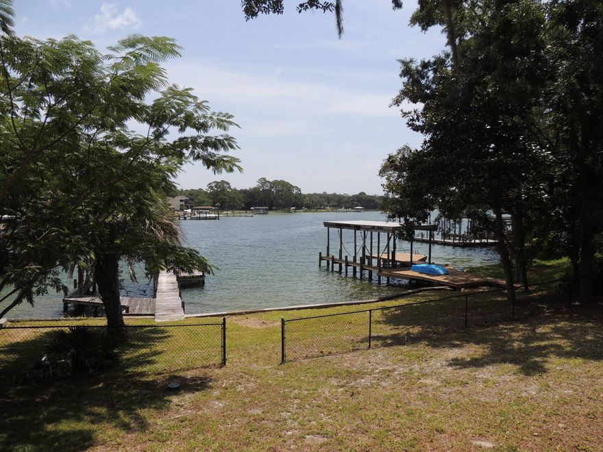 Lovely waterfront home in a great neighborhood. The wonderful floor plan has endless potential. You can spend hours watching the dolphins from this large 5 bedroom 3 1/2 bath home. Fresh, clean and convenient to everything. Vaulted ceilings and a cozy stone fireplace perfect for cold winter nights. Bring your boat - there is a deep water dock and boat slip. Buyer to verify all pertinent information including square footage and lot dimensions.Property being sold AS IS.