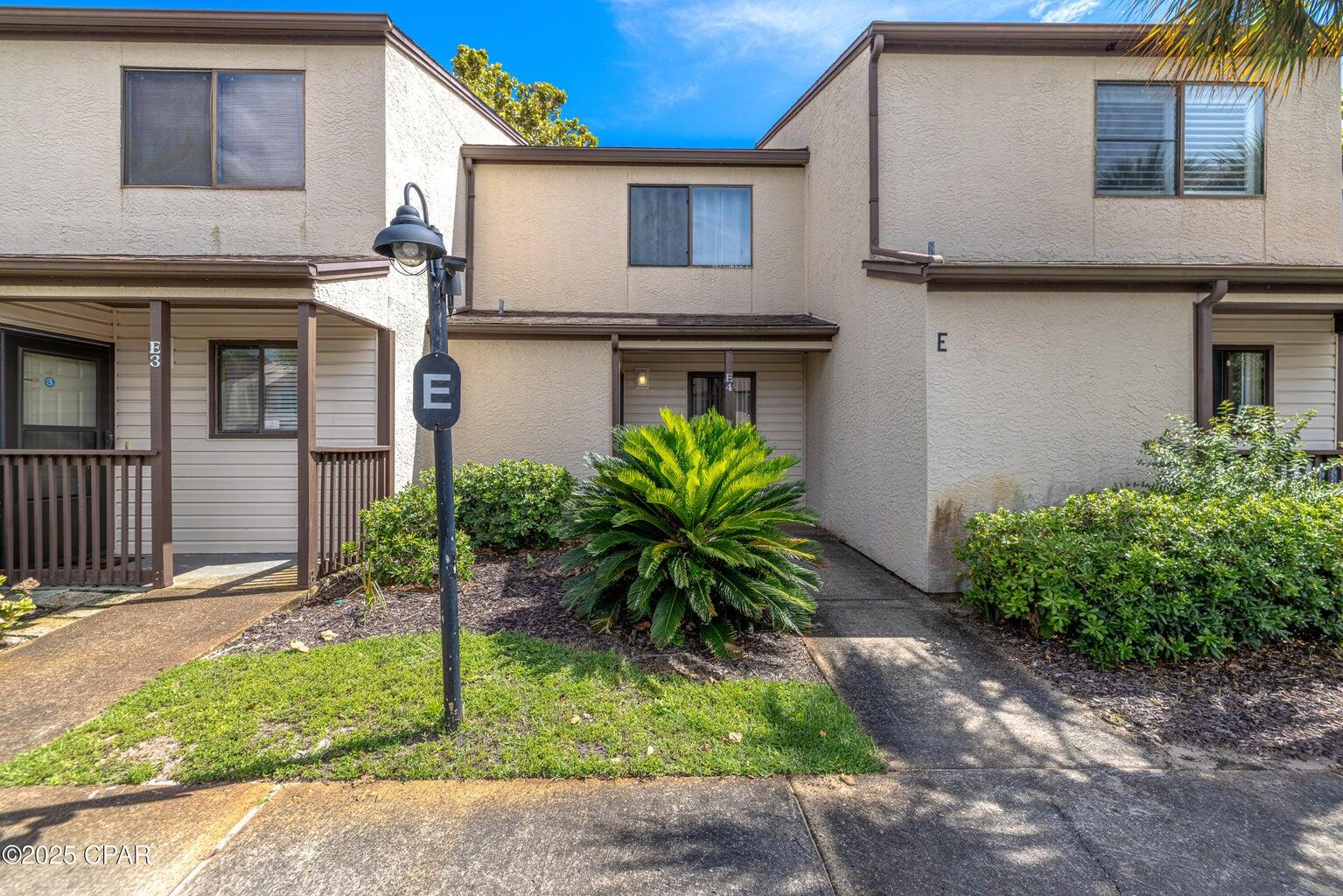 Discover this darling 2 bedroom, 2.5 bath condo in the highly sought after Portside Resort on Panama City Beach's desirable West End. This rare floor plan features two full bathrooms plus a half bath, a unique find in the community. The spacious master suite includes a newly added full bathroom and a private balcony, perfect for enjoying morning coffee. Unit E4 is in a great location within the resort, near one of three resort pools, including one with a waterfall and one that is seasonally heated, along with plenty of lounge areas. The community also offers a hot tub, tennis and pickleball courts, shuffleboard, horseshoes, and a large clubhouse with a pool table, darts, card tables, and a kitchen ideal for hosting dinners, game nights, or community events. Additional amenities include a a fitness room and lush, landscaped grounds! Portside is conveniently located directly across from Beach Access 70, and next to the local favorite Carousel Supermarket. You are also just minutes from Pier Park, Dolly Parton's Pirates Voyage Dinner Show, TopGolf, McGuire's Irish Pub, and endless shopping, dining and entertainment options, including picturesque 30A to the west. With similar units generating over $25,000+ annually in gross rental income, low HOA fees, and no milestone inspections, this property offers excellent rental potential or the perfect personal beach retreat.