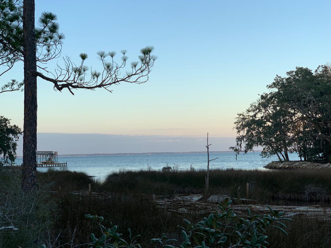 **This property is currently under contract, pending the sale of buyer's current home. Accepting backup offers.** This property is secluded and tucked away from the hustle and bustle of Highway 98. The parcel affords the buyer privacy with all the natural foliage and trees. Property offers Bay views. Backs up to small canal leading into the Bay. Canoe, paddle board or kayak from your back yard.