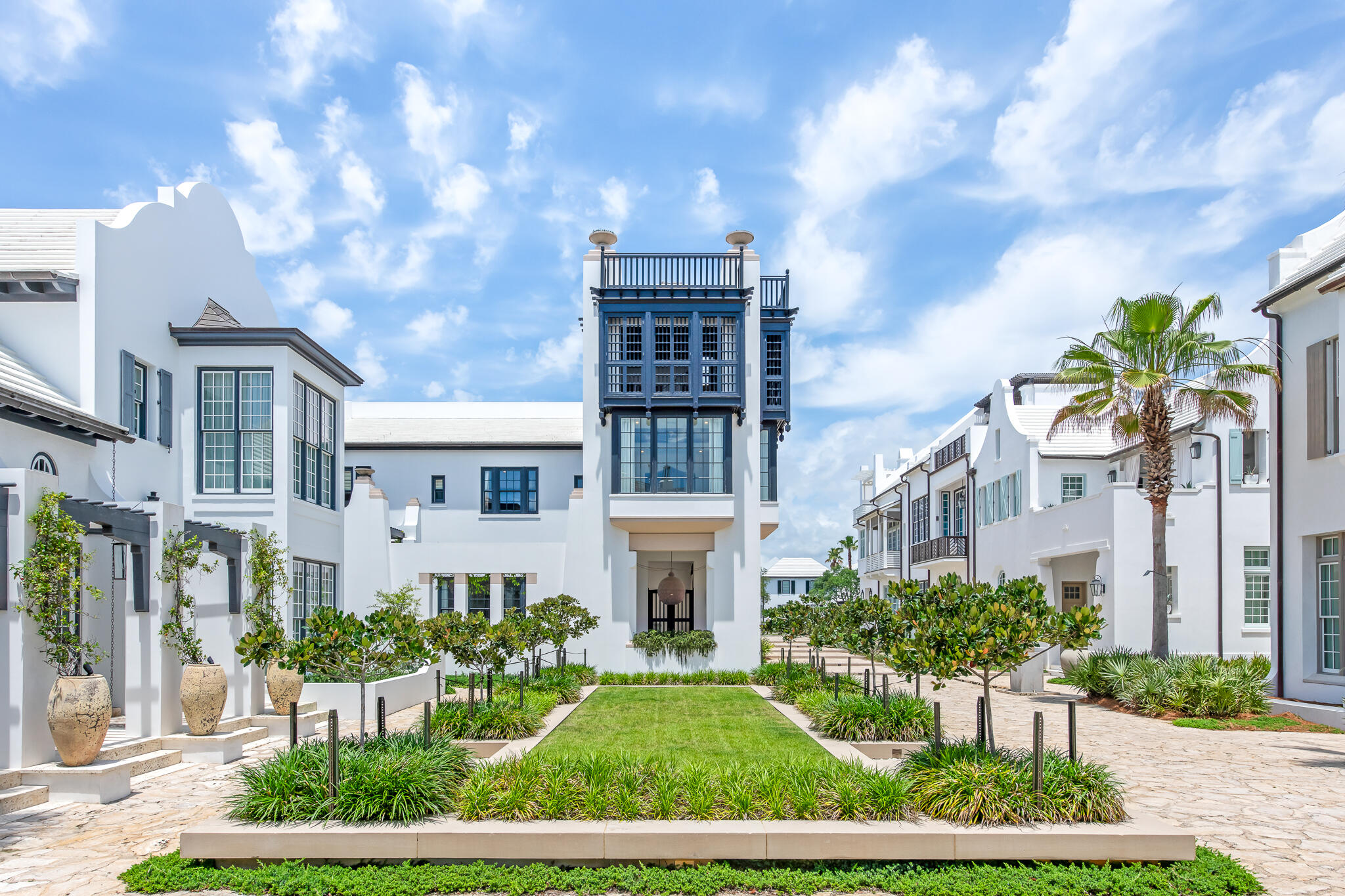 25 Moongate Court is one of the Khoury Vogt designed gems of Alys Beach. This Moroccan influenced custom design benefits from a rare tower designation which allowed for a 4th floor rooftop terrace and a 3rd floor Florida room, both with unparalleled views of Sea Garden Park and the emerald waters of the gulf. Throughout the house are rich textures, natural elements, and a mix of old world antiquity with modern influence. The first floor great room and kitchen feature 13-foot ceilings. Adjoining these spaces is an oversized lushly landscaped courtyard with a heated pool, 2 loggias overlooking Sea Garden Park, and an al fresco dining court. The primary suite has 3 sides of windows looking out to the Sea Garden pedestrian path and down to the beach access crossover. This is a rare opportunity to own such a special home south of 30A in Alys Beach.