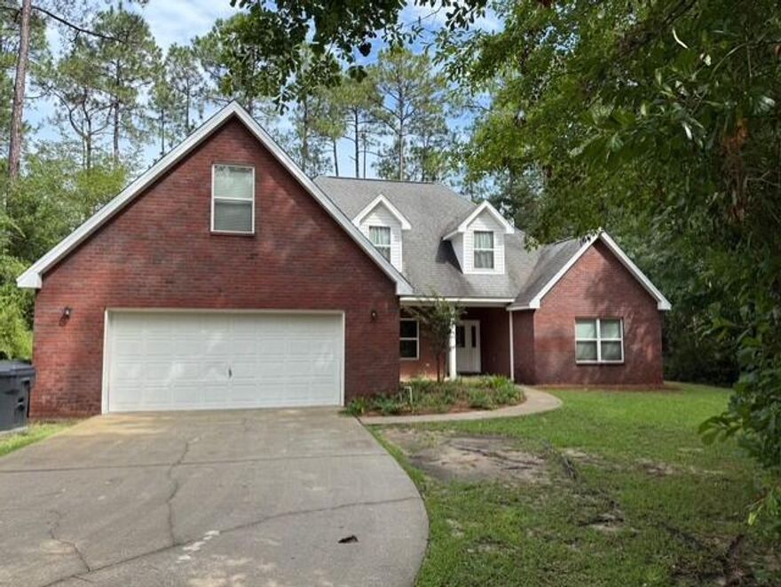 Fantastic home located in Freeport! This beautiful all brick 4 bedroom 2 bath home features a 2 car garage, screen in back porch, large wooded and secluded lot with no HOA, and plenty of parking.  This home aslo features a formal dining room, fire place in the living room and primary bedroom along with lots of hard wood floors and tile in the wet area.  This split bedroom plan also includes an additional bonus room above the garage for an office, extra bedroom, or studio. Pet fee is $300 per month