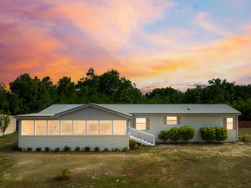Welcome to this beautiful home situated on a spacious 0.622-acre property, just under a mile from the county public boat ramp and offering scenic views of Bear Creek and the Deer Point Lake area. The property features a charming screened front patio that overlooks the expansive front yard and elevated lot, providing a peaceful setting for enjoying the surrounding natural beauty. Inside, the thoughtfully designed split-bedroom floor plan includes a spacious primary suite featuring a sitting area, soaking tub, separate shower, and generous closet space. The home offers two inviting living areas. The primary living room was designed with a designated area for entertainment systems, creating an ideal space for gatherings. An additional family room includes an electric fireplace, adding warmth and character to the home. The kitchen is equipped with beautiful cabinetry and stainless steel appliances, offering both style and functionality. The fenced backyard area offers a private outdoor space, and two custom-built sheds will remain with the property. Recent energy-efficient improvements include foam panel insulation between the joists and porch, contributing to reduced energy costs, with the current owners experiencing an average power bill of approximately $110 per month for two occupants. This home is serviced by a private well and septic system. Located just moments from boating and outdoor recreation opportunities, this home offers a unique combination of space, comfort, and convenience.