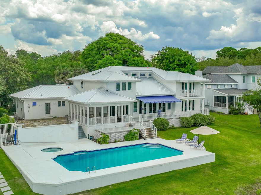 Your Paradise on the Point awaits! This newly updated & meticulously maintained, custom home is nestled on a private, 1 acre cul-de-sac lot with 200 waterfront feet on Santa Rosa Sound. Enjoy uniquely spectacular sunsets & panoramic views of the Santa Rosa Sound, Intercoastal Waterway & Navarre Beach skyline from the newly built dock & boat house. The new metal roof, hvac and hot water heater affords comfort and worry free living! Fall in love with life on 'the point.' Breathtaking outdoor spaces include mature landscape as well as covered & open patios. This is your private waterfront oasis. Enjoy a spectacular view from the ground floor primary suite balcony and take a dip in the pool or spa. Soaring ceilings & large, full view windows & doors welcome you to bright, light, open living 
& dining areas which flow onto your outdoor space. A large, updated kitchen with both casual and formal dining areas offers great flow & easy living. The split floor plan is perfect for primary living downstairs while offering 3 private guest rooms upstairs. A safe room for important items & a remote guest/ hobby/ workspace with private bath are a few of the unique features of this home. This one is a MUST SEE! Whether entertaining a large group or enjoying a quiet evening on your boat dock, this is your sanctuary. This well-designed home offers generational live, work & play spaces, making this the place to live your best waterfront life. Private tours available.

