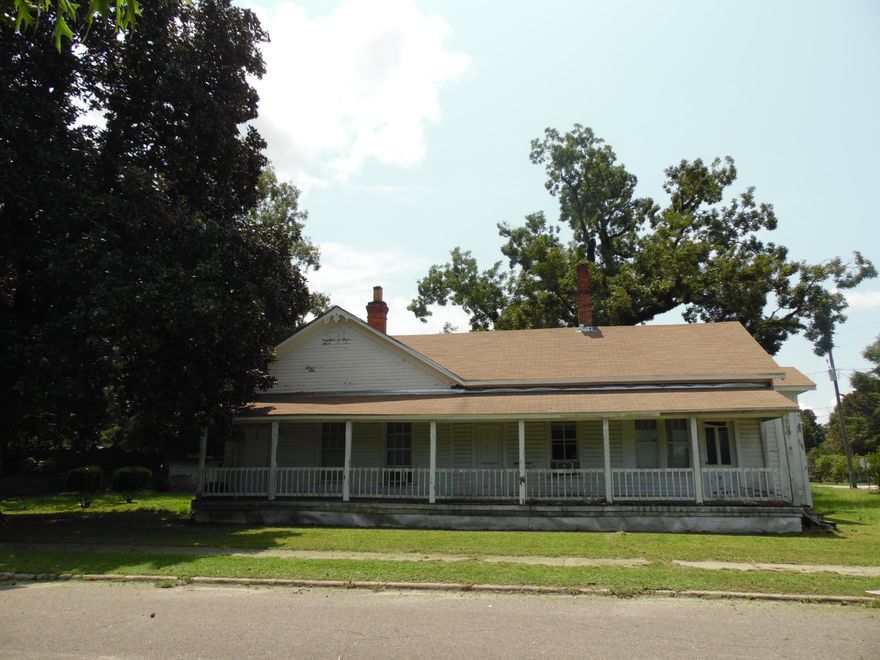 Have you ever wanted to own Vintage home to restore that has that has tremendous character ...this is it! Now you may own your own piece of DeFuniak Springs history with this charming home. It is located on three city lots with fully grown pecan, oak and magnolia trees. The total sf is 2,898 with a base area of 1,950: 3 bedroom 1 bath. This home was one of the first homes built in Historic DeFuniak Springs. According to the abstract of title the property was originally deeded to the Pensacola and Atlantic Railroad Co. It was used to house workers who were working on the railroad we were told. Over the years it has been modified. SELLER IS REMOVING WINDOW AIR UNITS AND APPLIANCES
CLICK ON MORE TAB TO READ MORE: It has a large 8x52' front porch across the entire front that invites you into a large living room  14x17 with Parlor/family room 14x17' and foyer area12x8'.  A large kitchen/dining room is at the back of the home...with breakfast bar.   It should easily hold a formal dining room suite, plus area for breakfast nook table set.  Seller has installed a new shingle roof and made other repairs.   It is located  just 3 blocks from Lake DeFuniak. Also has large detached storage building.  Easy to view...