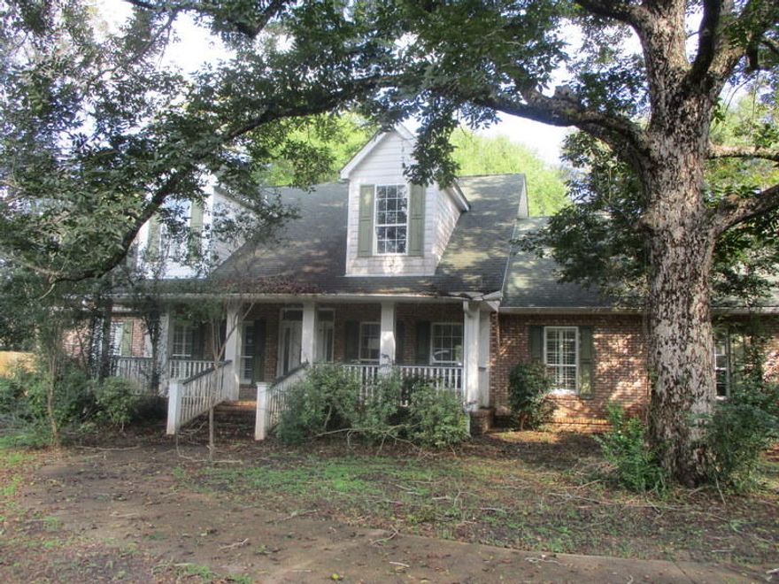 This REO opportunity is THE home you have been waiting for! some cosmetic work and this property will shine like a new star! Home was built in 2006 and is nearly 4000sf. Home rests on approx 1.47 acres and has privacy fenced back yard, open deck on back, with large porch on the front. Front yard is partially fenced and there is an oversized 2 car side entry garage. Home is massive with every inch of space used! Master bedroom with large master bath downstairs as well as an additional guest bedroom and bath. Open floor plan design with granite tops in kitchen, built in bookshelves and fireplace in living room. Upstairs 3 more bedrooms and another full bath. If you have been looking for something to sink your teeth into, with lots of equity opportunity, this is it! Call today!