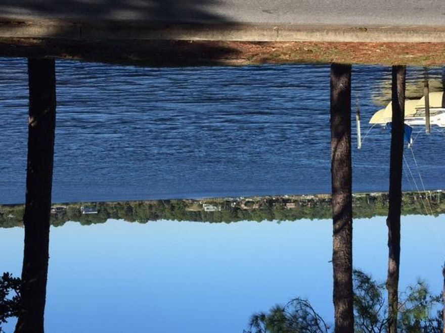 Enjoy the stunning view of the Bayou from the livingroom of this 4 bedroom 2 bath home. Lovingly maintained home with new flooring and fresh paint throughout across the street from Boggy Bayou ready to be called home. 4 bedrooms and 2 full baths with large eat in kitchen and indoor laundry area off the kitchen. Large yard with plenty of shade from mature trees and room to enjoy the one of a kind views. 2 car detached garage with extra storage in the back yard by the private circular driveway. Owner will consider a pet with a $250 yearly non refundable pet fee and a one time $250 refundable pet deposit due at lease signing. Carpet cleaning and re-key fee due upon lease signing. Call today for your viewing appointment.